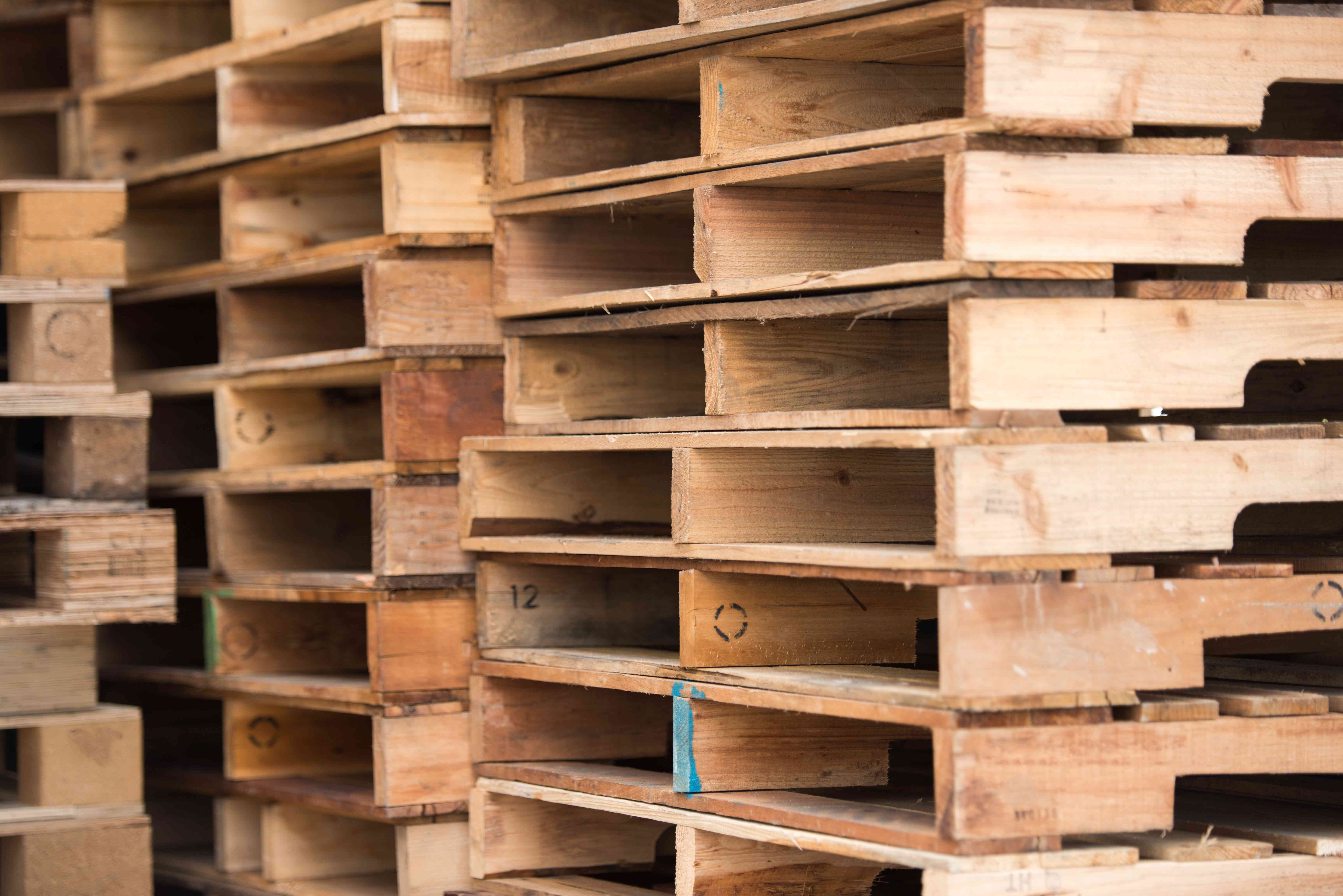 A photo of stacks of GMA wood pallets
