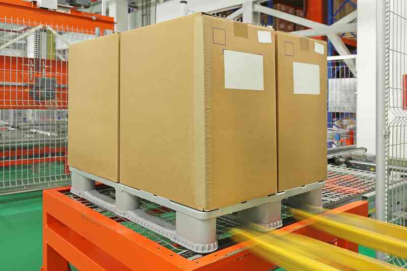 forklift moving a loaded pallet