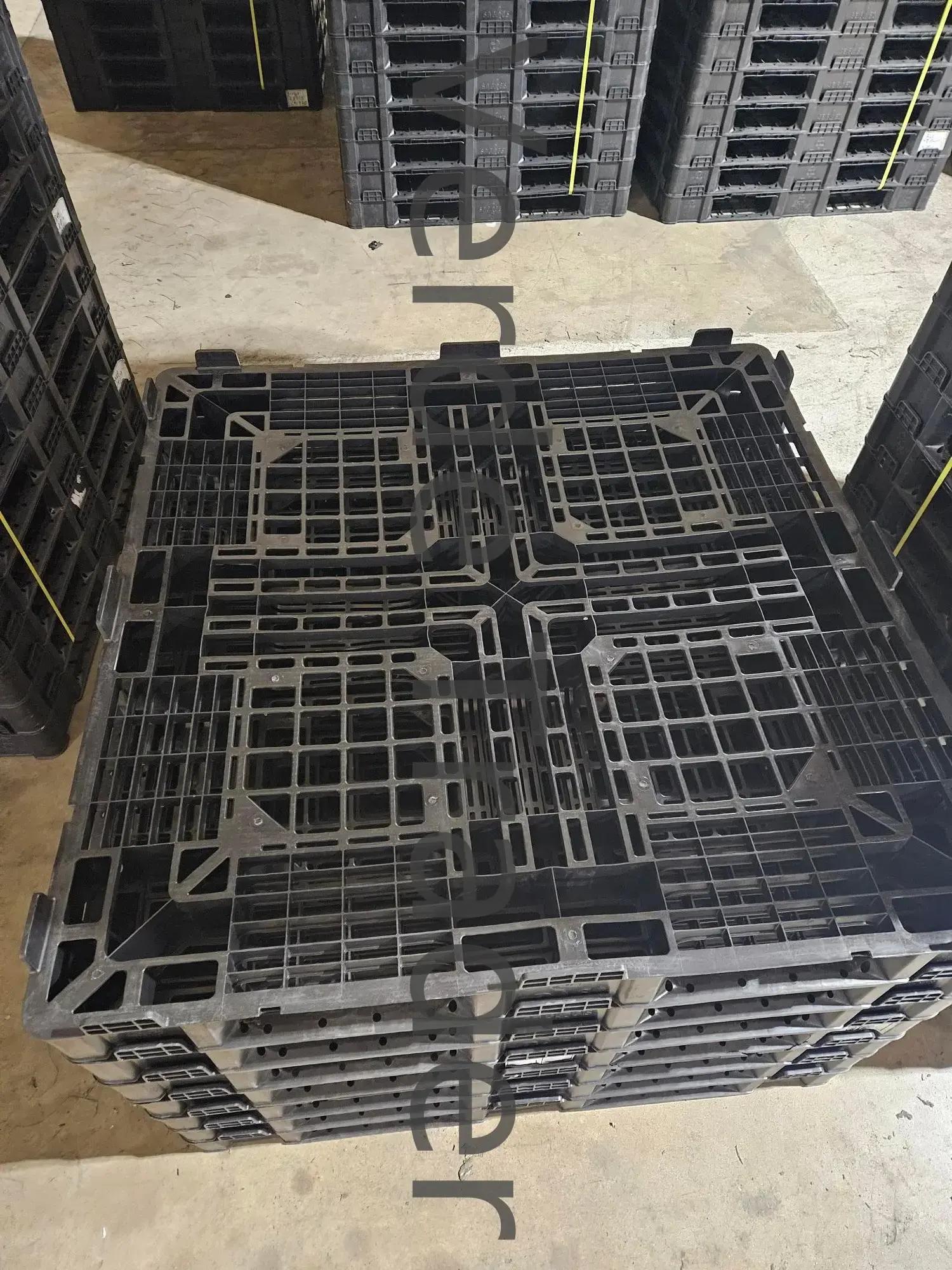 Underside of a stackable plastic pallet showing the interlocking foot pattern