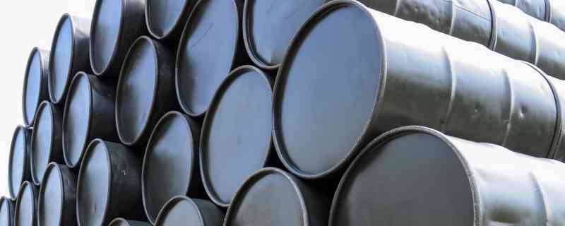 stacks of used, black steel drums