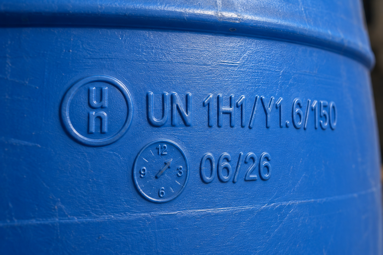 Close-up of the manufacture date and UN markings molded into a plastic drum
