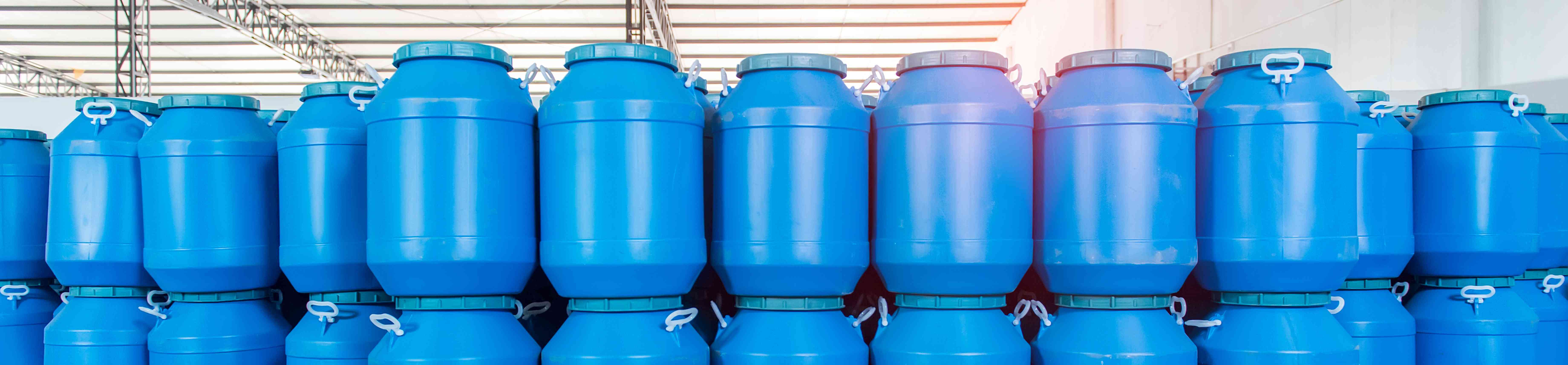 Photo of stacks of 30-gallon plastic drums