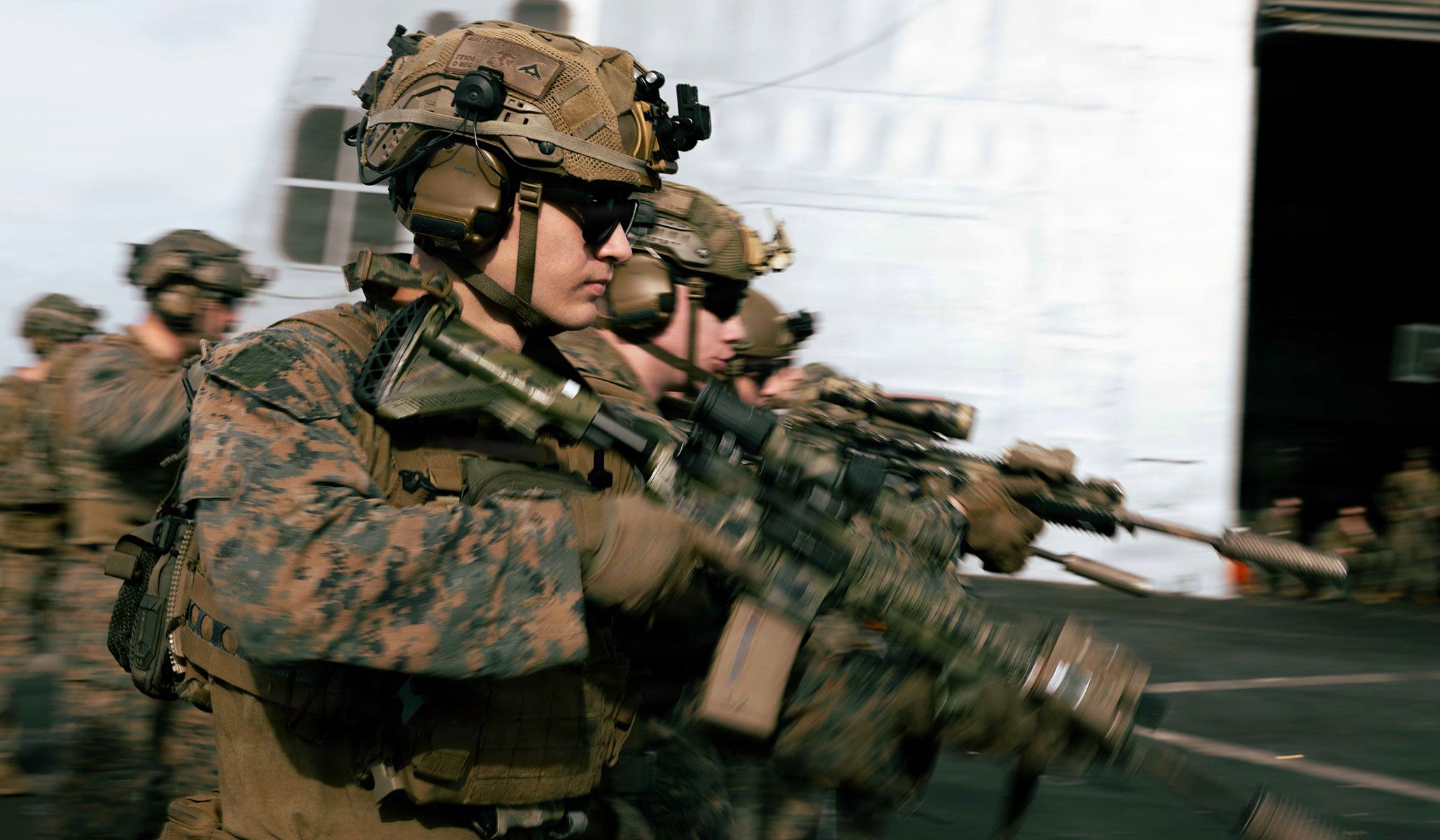 U.S. Marines with Lima Company, Battalion Landing Team 3/6, 22nd Marine Expeditionary Unit (Special Operations Capable), conduct a firing-while-moving drill during a deck shoot aboard the amphibious transport dock USS <i>San Antonio</i> (LPD-17), under way in the Caribbean Sea, April 14, 2026.