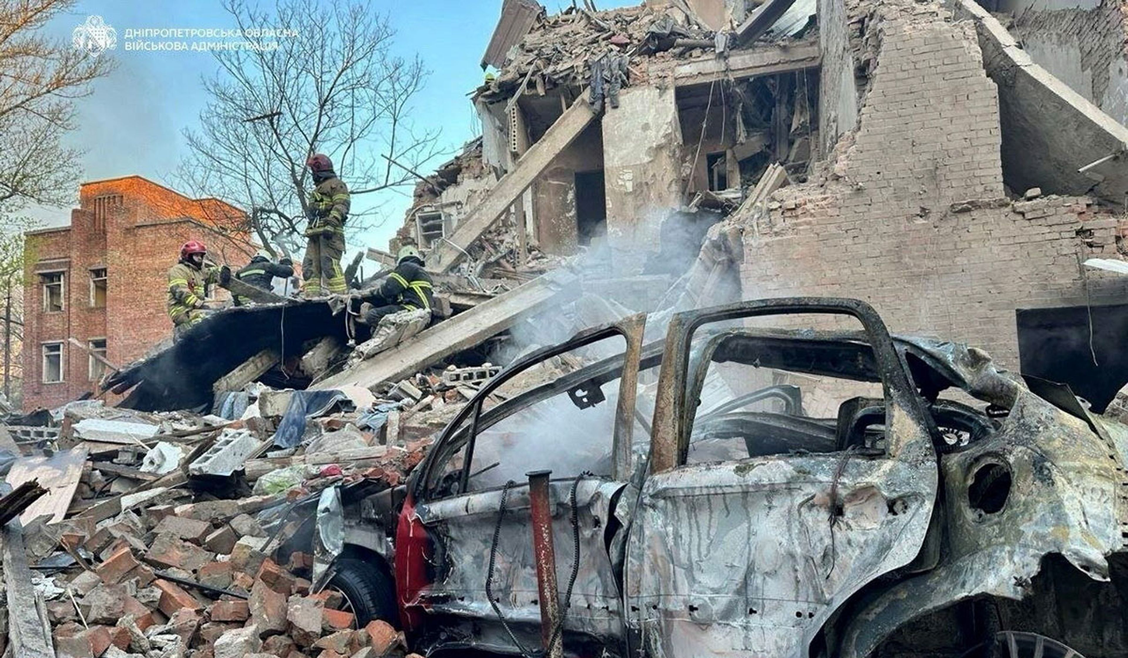 Rescuers work at the site of an apartment building hit by a Russian missile and drone strike in Dnipro, Ukraine, in a handout picture released on April 25, 2026.