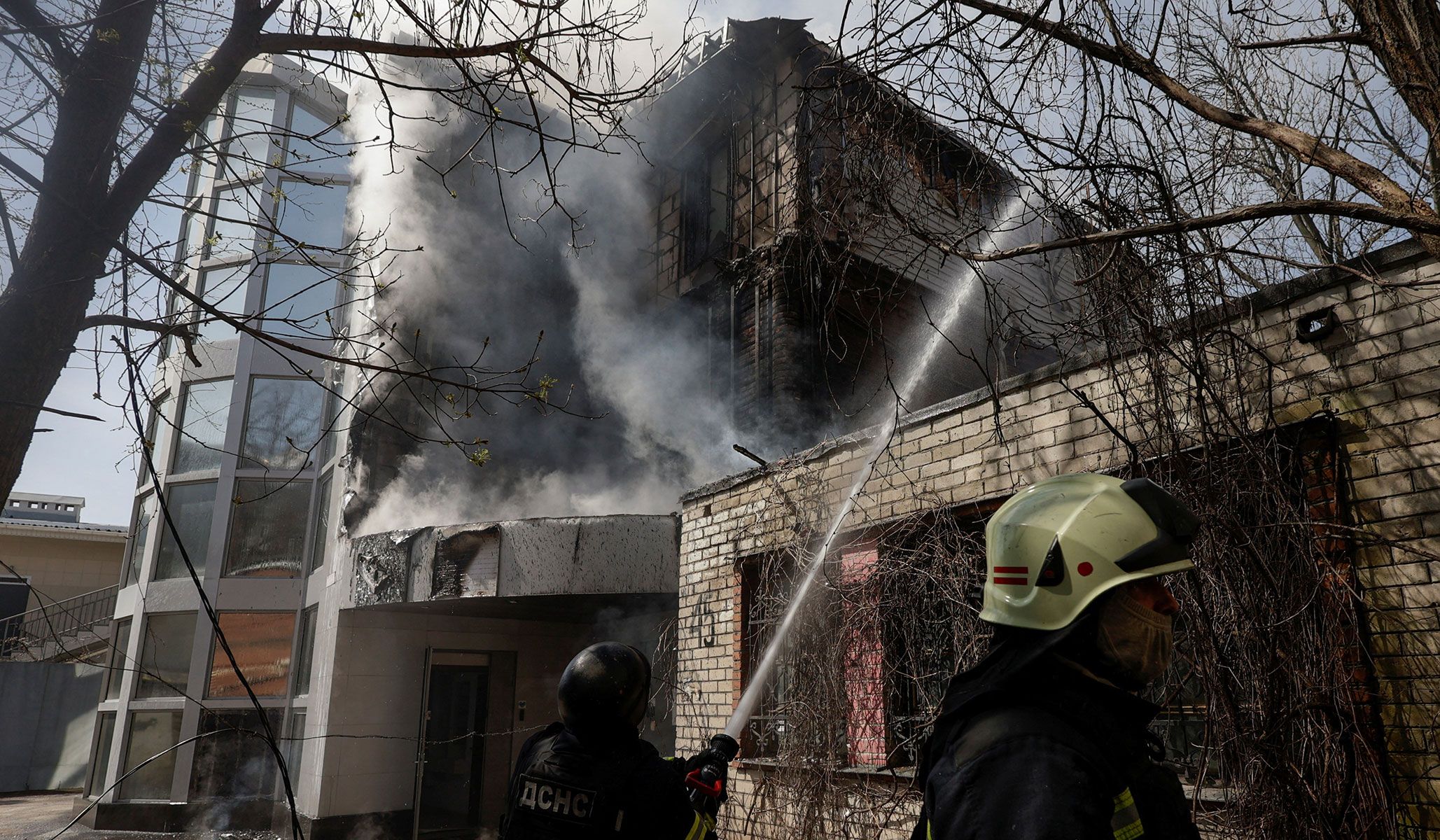 Firefighters work at the site where an office building was hit by a Russian drone strike in Kharkiv, Ukraine, April 16, 2026.