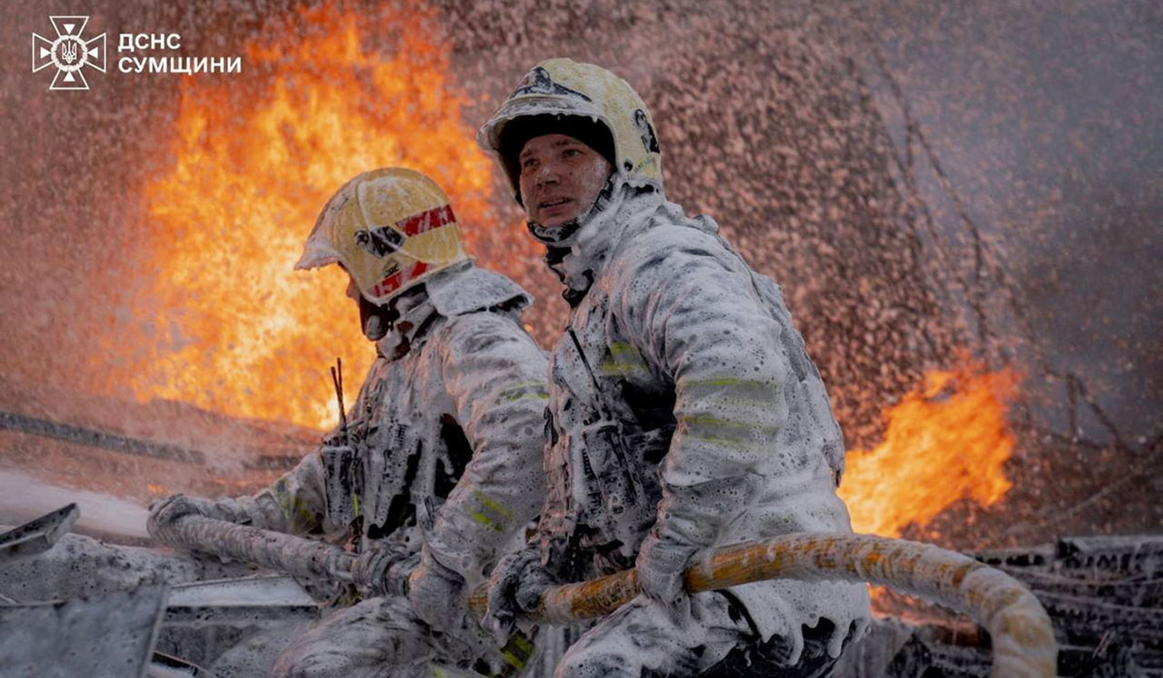 Firefighters work at the site of a building hit by a Russian drone strike in Sumy, Ukraine, in a handout picture released April 15, 2026.