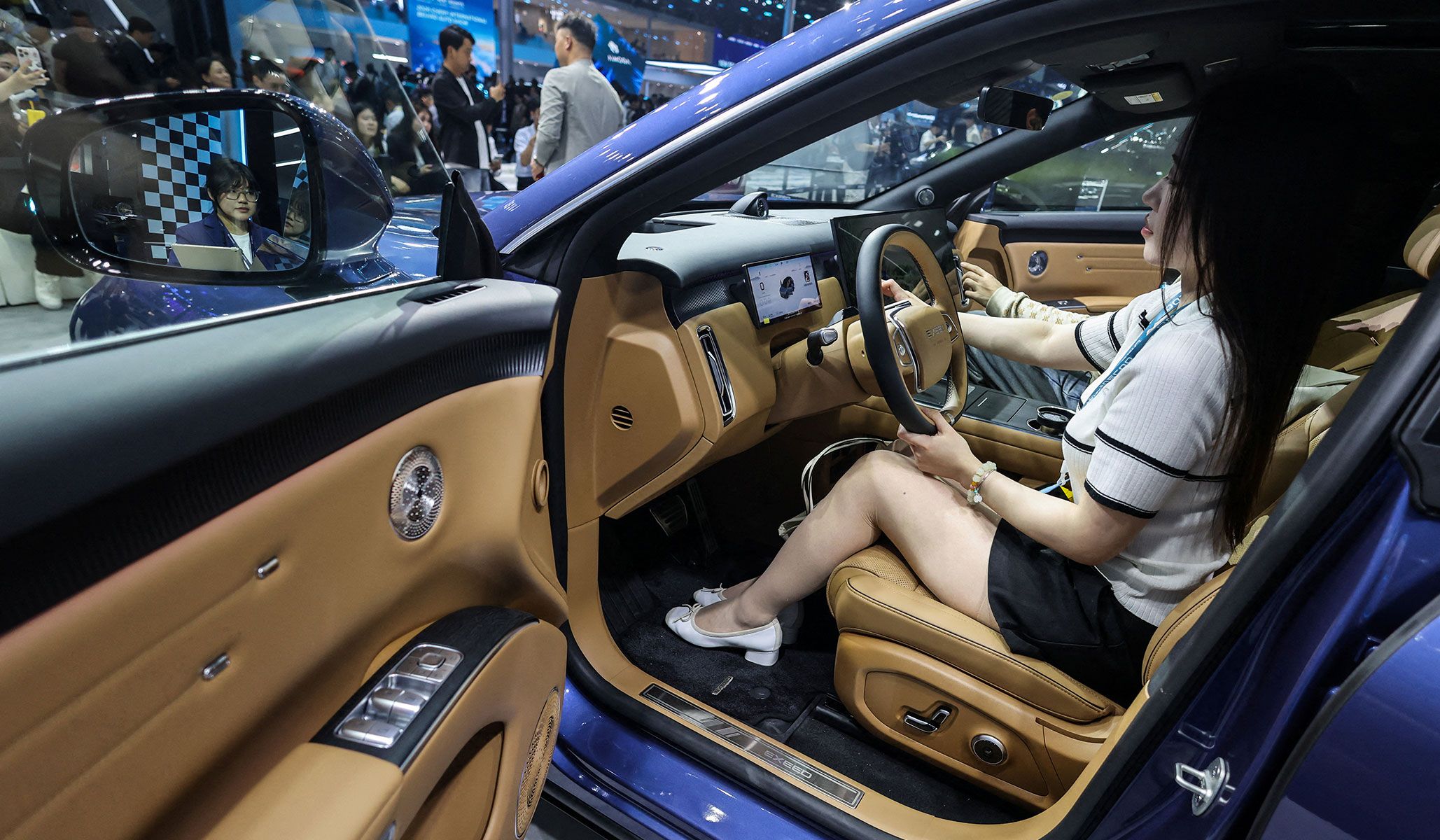 A woman sits inside the newly presented Chery’s Exeed model EX7 SUV at the Beijing International Automotive Exhibition in Beijing, China, April 24, 2026.