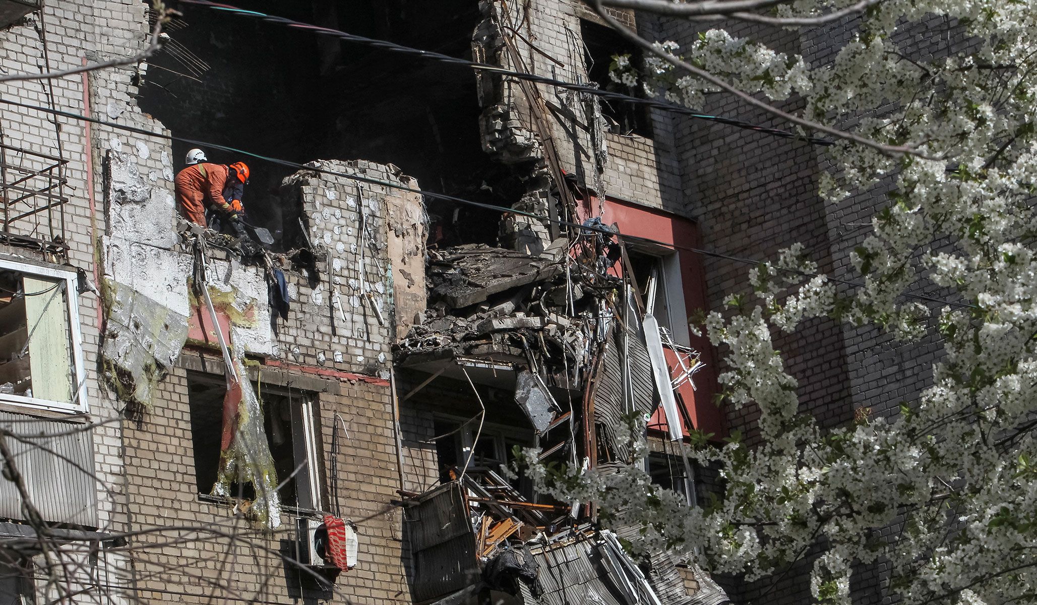 Rescuers works at a site of an apartment building hit by a Russian drone strike in Dnipro, Ukraine, April 23, 2026.