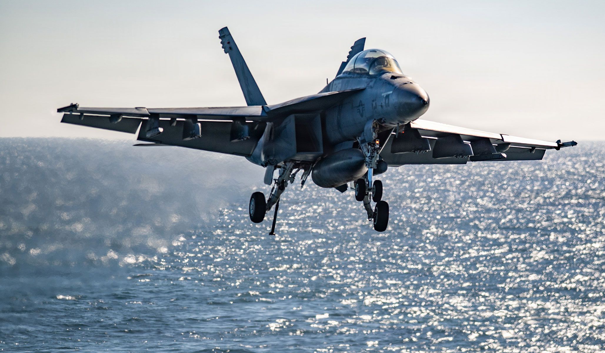 A U.S. Navy F/A-18F Super Hornet attached to the “Kestrels” of Strike Fighter Squadron VFA-137 prepares to make an arrested landing on the flight deck of the aircraft carrier USS <i>Nimitz</i> (CVN-68), under way in the Pacific Ocean, April 21, 2026.