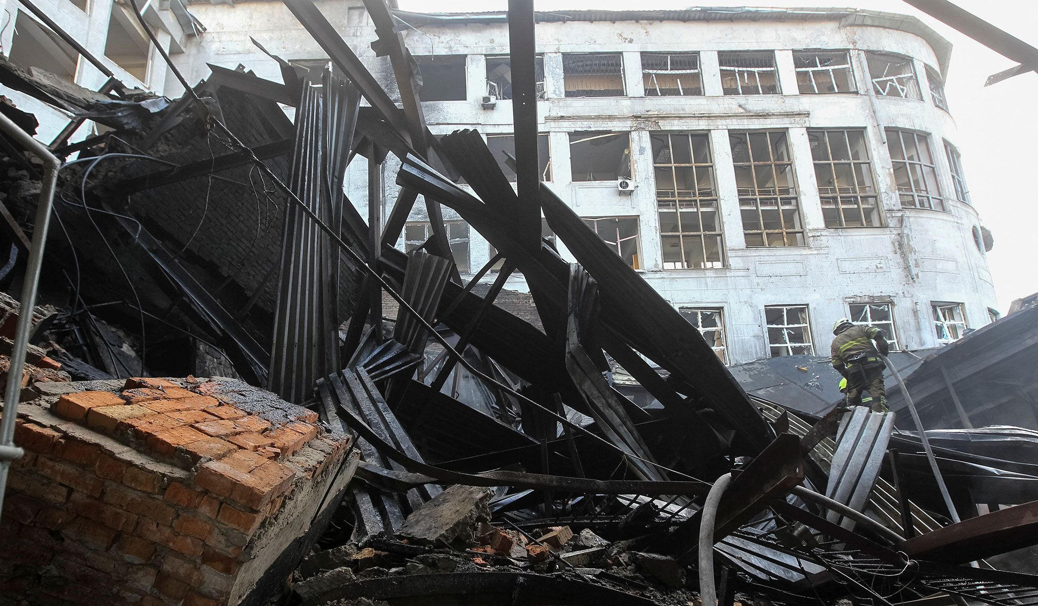 A rescuer works at the site of a university's building hit by a Russian drone strike in Dnipro, Ukraine, April 15, 2026.