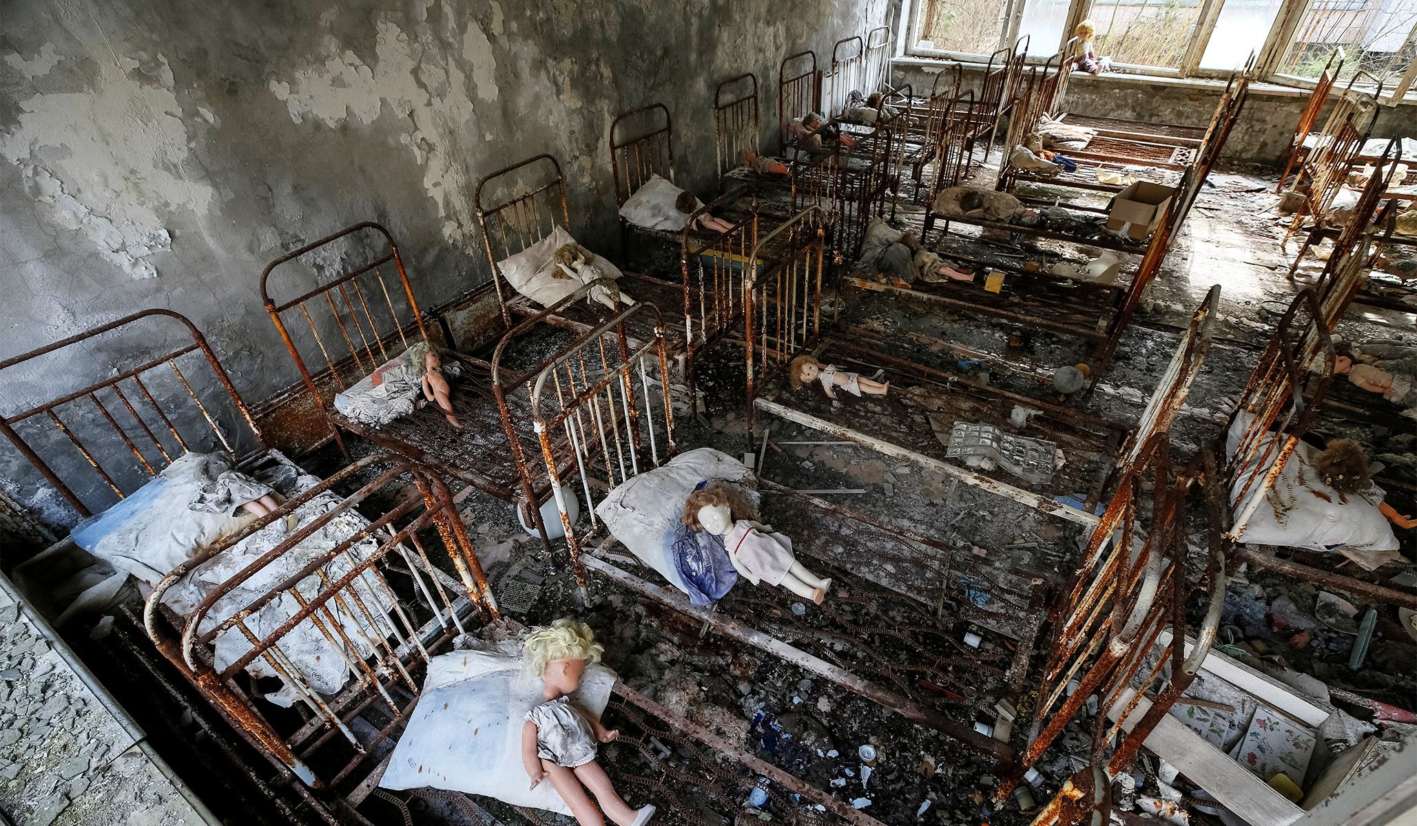 Dolls placed by a visitor lie at beds at a kindergarten in the abandoned city of Pripyat near the Chernobyl nuclear power plant in Ukraine, April 5, 2017.