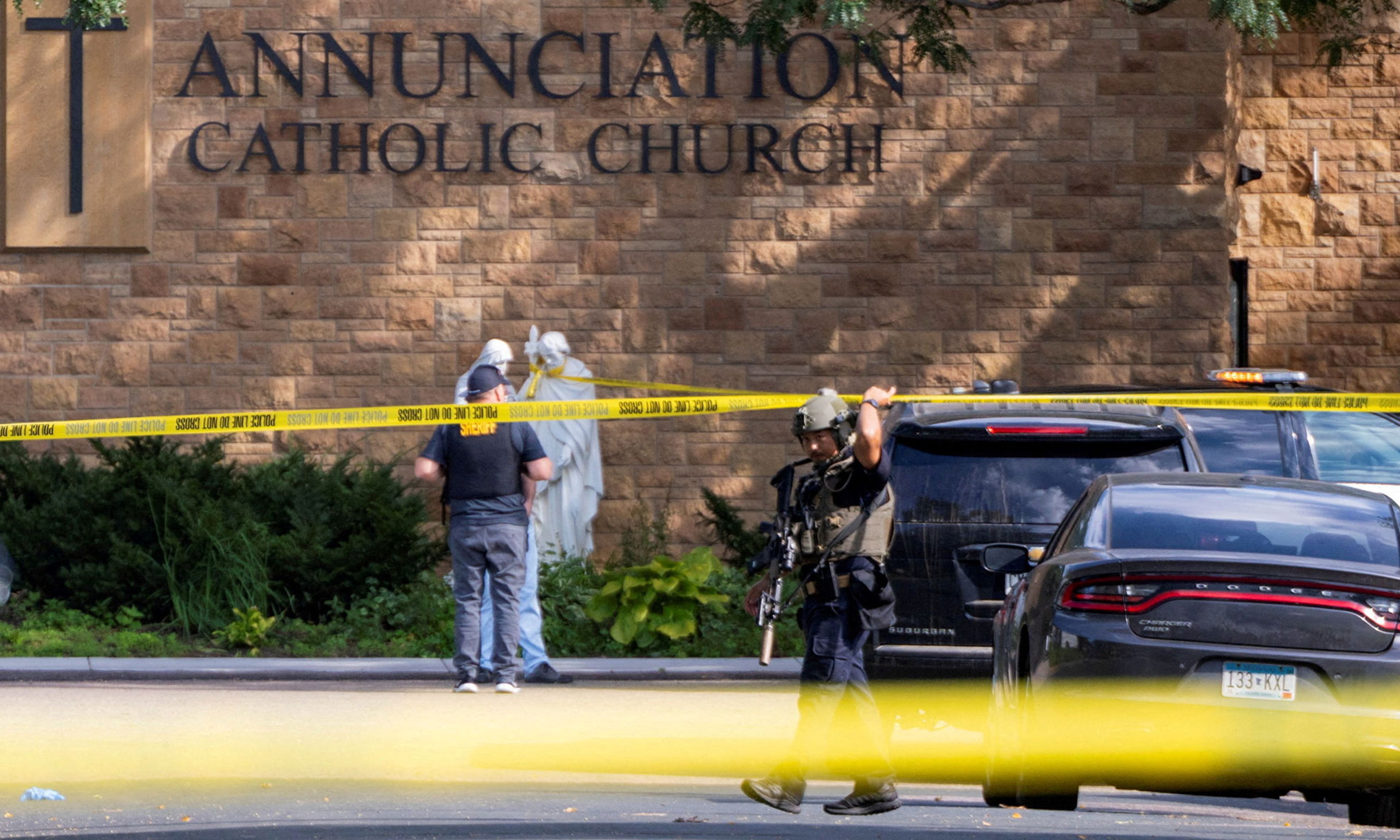Law enforcement officers set up barriers after a shooting at the Annunciation Church, which is also home to an elementary school, in Minneapolis, Minn., August 27, 2025.