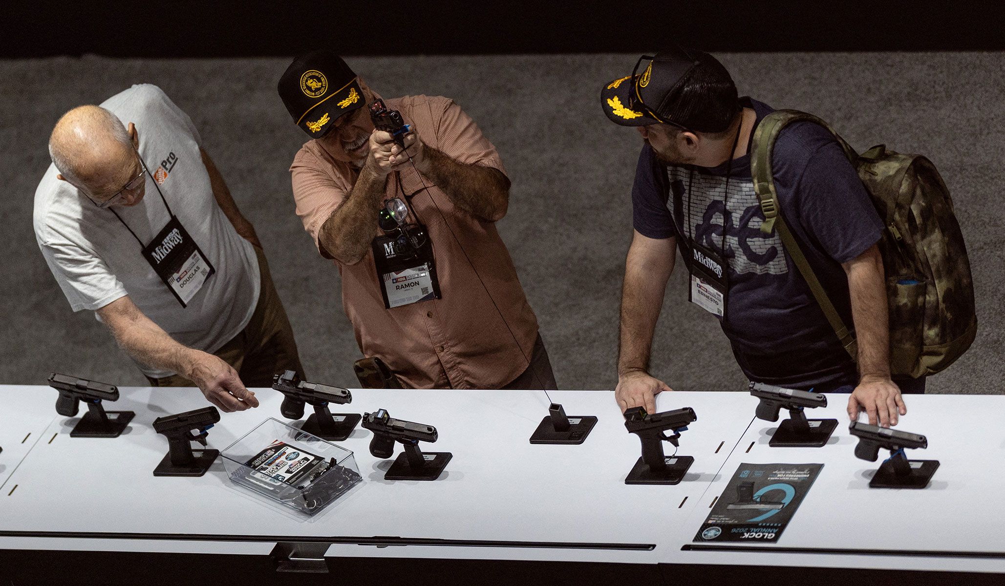 A visitor handles a gun at an exhibition booth during the National Rifle Association's annual meetings and exhibits in Houston, Texas, April 17, 2026.
