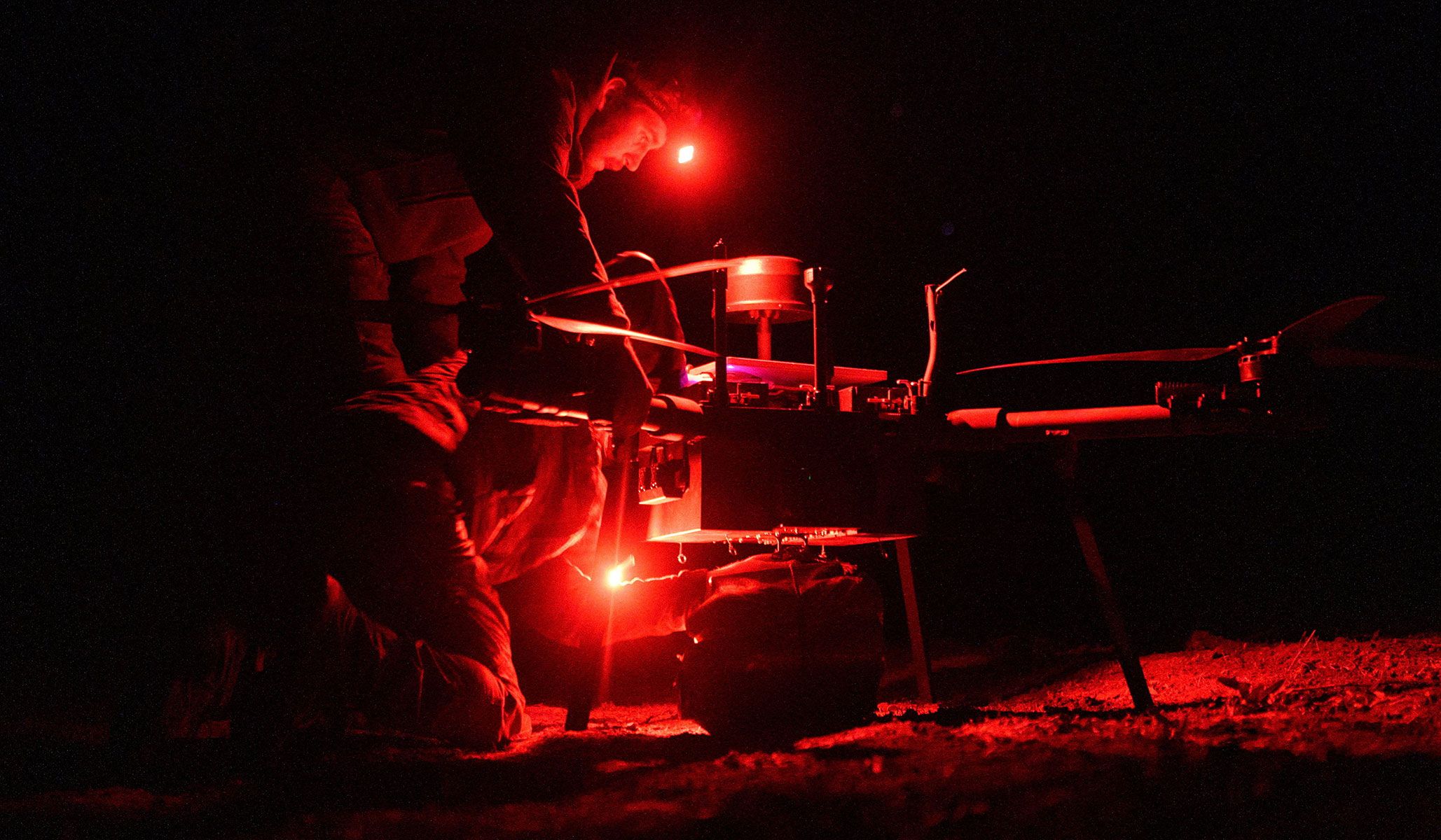 Service members of the 154th Separate Mechanized Brigade of the Ukrainian Armed Forces attach ammo and food to a heavy drone before delivering it to a position of their brothers-in-arms near a front line in Zaporizhzhia Region, Ukraine, April 6, 2026.