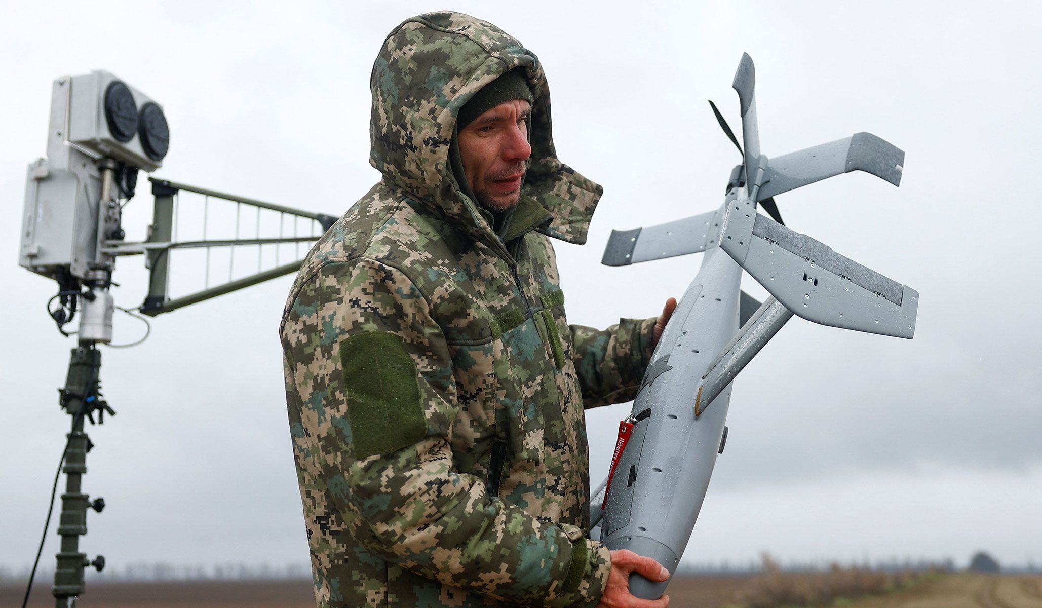 Ukrainian service member Anatolii carries an AS3 interceptor unmanned aerial vehicle, part of a MEROPS modular American-made, AI-powered counter-drone system, during training in an undisclosed location in Ukraine, April 10, 2026.
