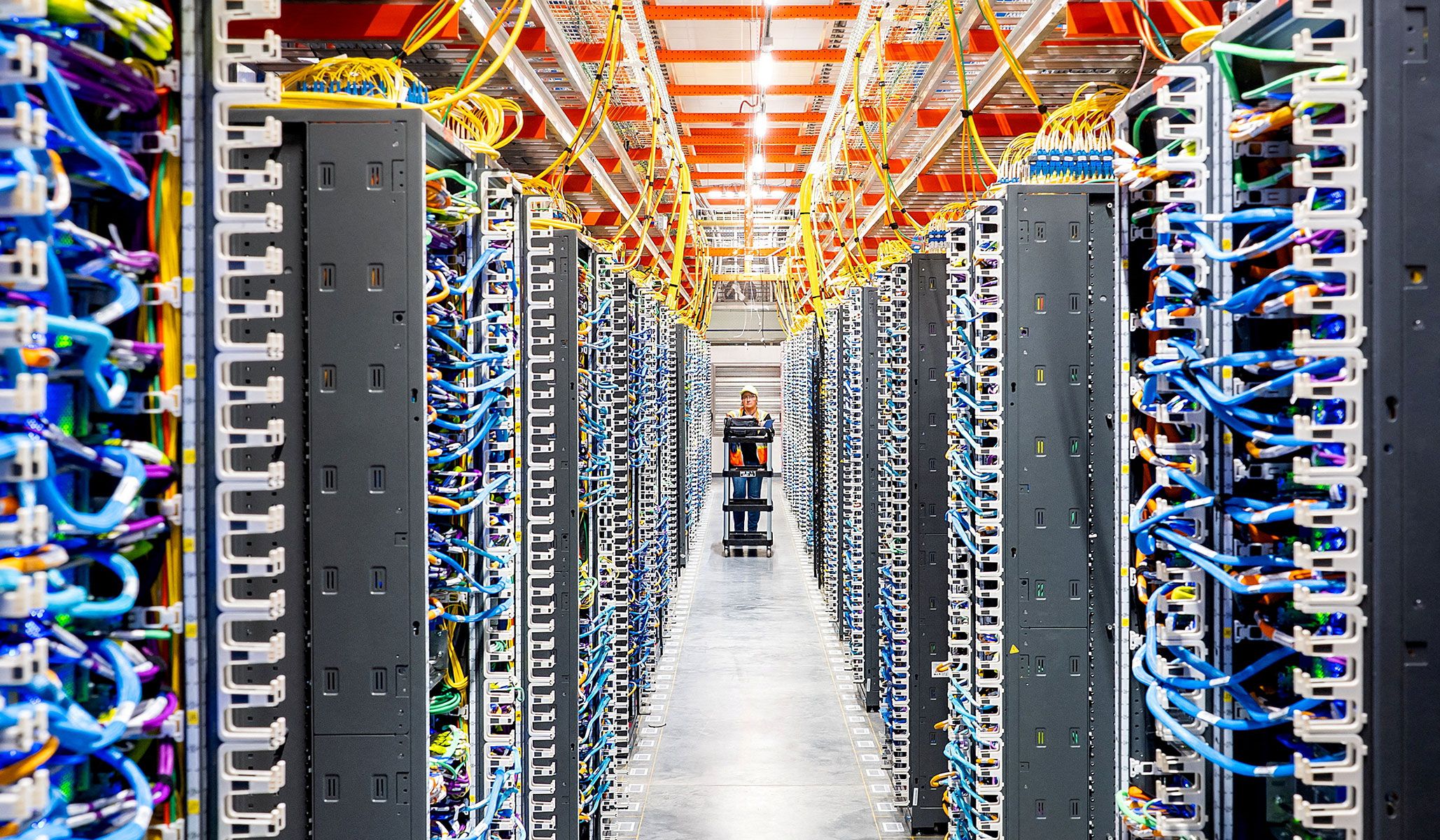 Rows of servers inside an Amazon Web Services data center, part of the massive computing infrastructure that powers modern AI.