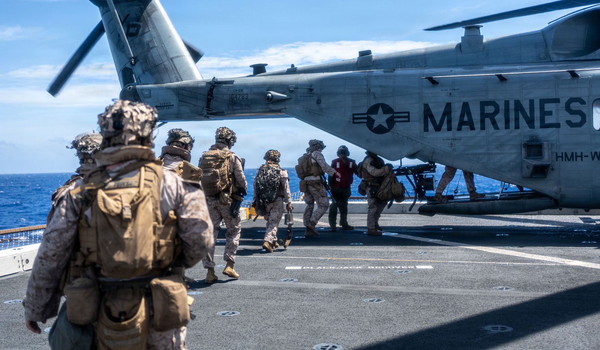 U.S. Marines with Lima Company, Battalion Landing Team 3/5, 11th Marine Expeditionary Unit, embark a CH-53E Super Stallion with the “Evil Eyes” of Marine Medium Tiltrotor Squadron VMM-163 (Reinforced), 11th MEU, during a quick reaction force drill aboard the San Antonio-class amphibious transport dock ship USS <i>Portland</i> (LPD-27), under way in the Pacific Ocean, April 14, 2026.