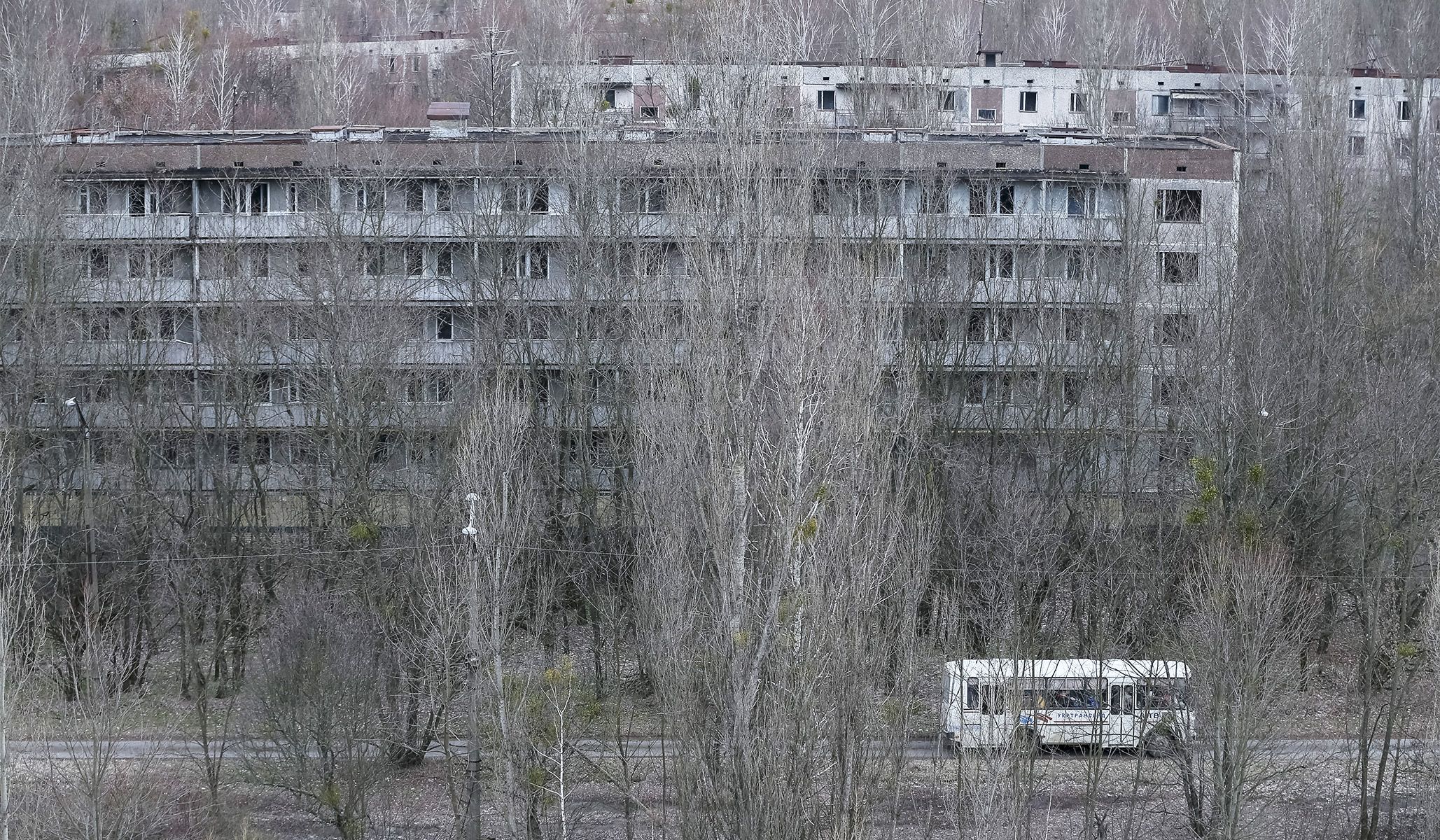 Employees ride a bus in the abandoned city of Pripyat near the Chernobyl nuclear power plant in Ukraine, March 23, 2016.
