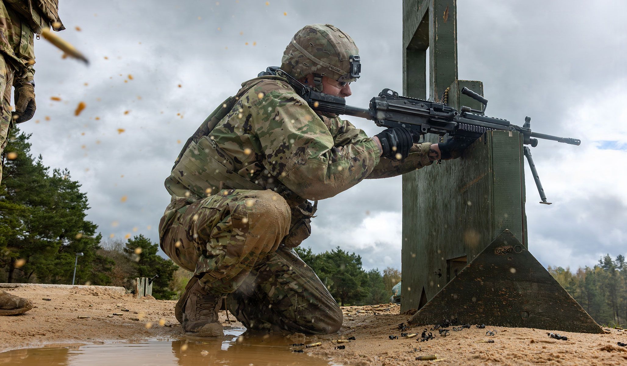 U.S. Army Specialist Matthew Falone, a bridge crewmember assigned to the 18th Military Police Brigade, 21st Theater Sustainment Command, fires his M249 light machine gun during a weapons qualification as part of the 21st Theater Sustainment Command Best Squad Competition at U.S. Army Garrison Bavaria, Germany, April 19, 2026.