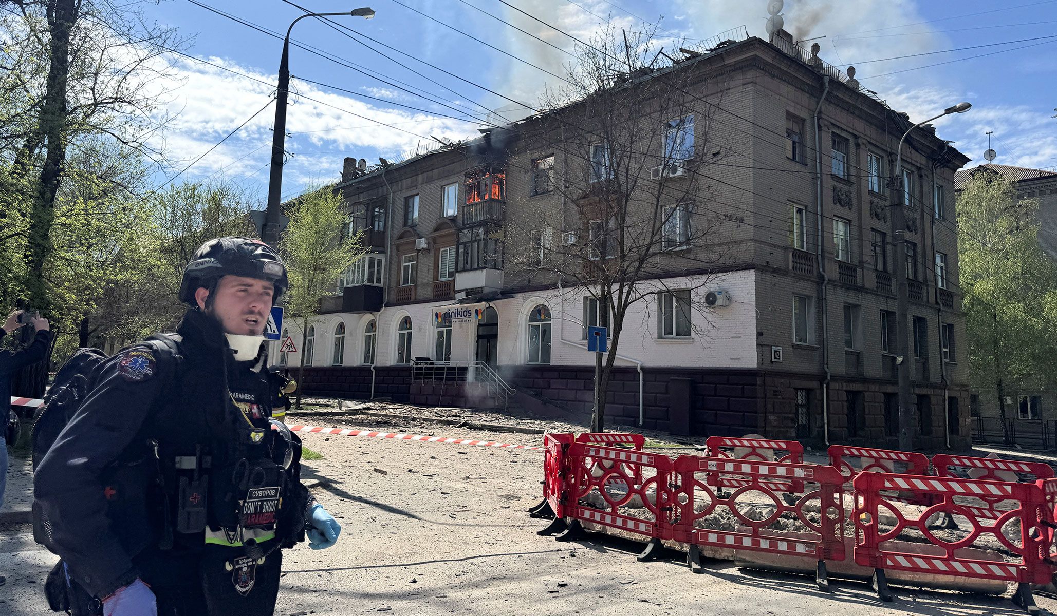 A medical worker stands at the site of an apartment building hit by a Russian drone strike in Zaporizhzhia, Ukraine, April 17, 2026. Picture taken with a mobile phone.
