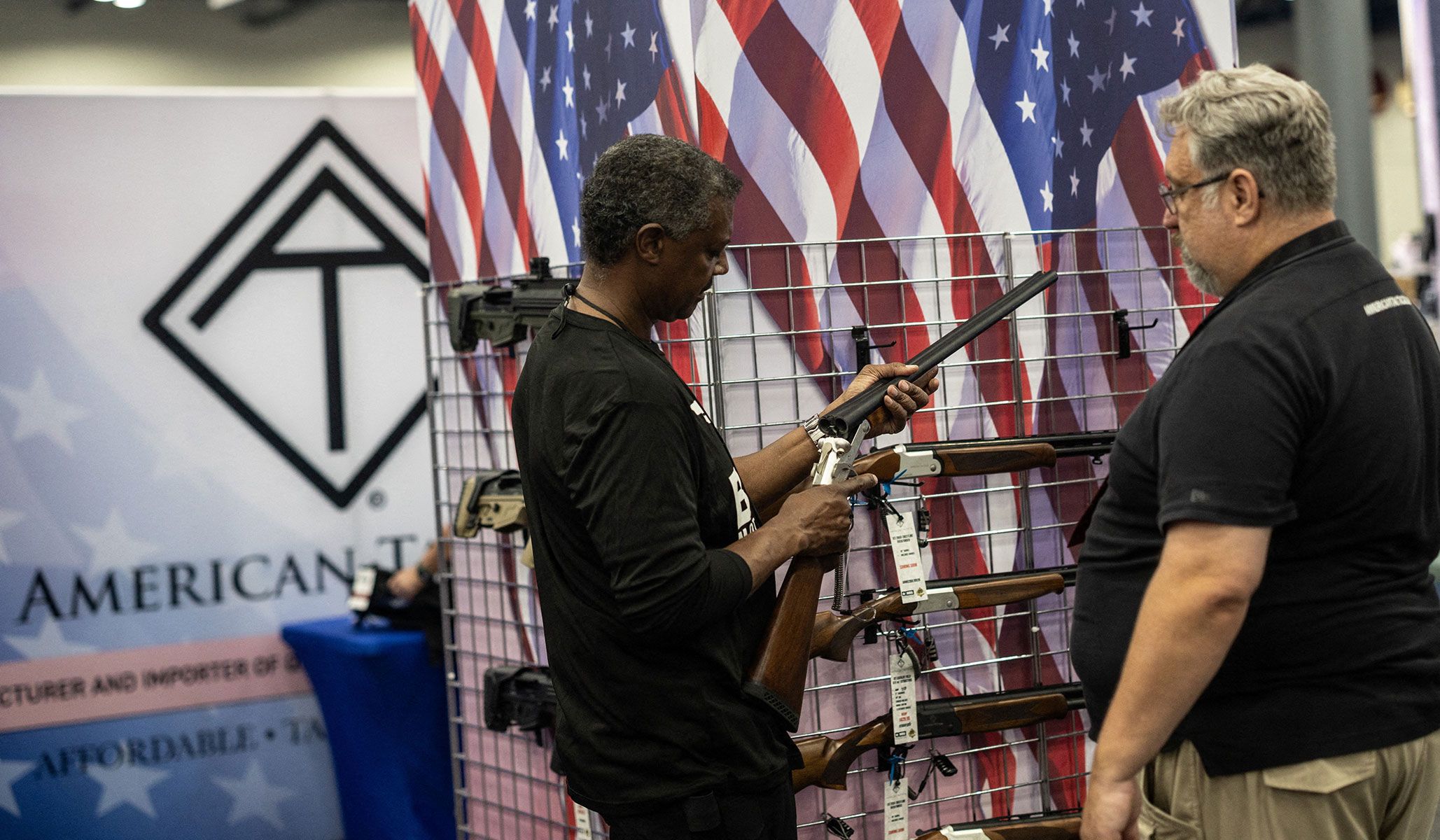 A man looks at rifles during the National Rifle Association's annual meetings and exhibits in Houston, Texas, April 17, 2026.