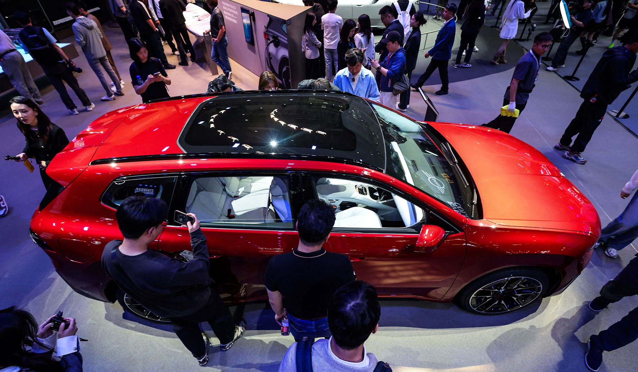 People gather around the BMW iX3 model at the Beijing International Automotive Exhibition in Beijing, China, April 24, 2026.