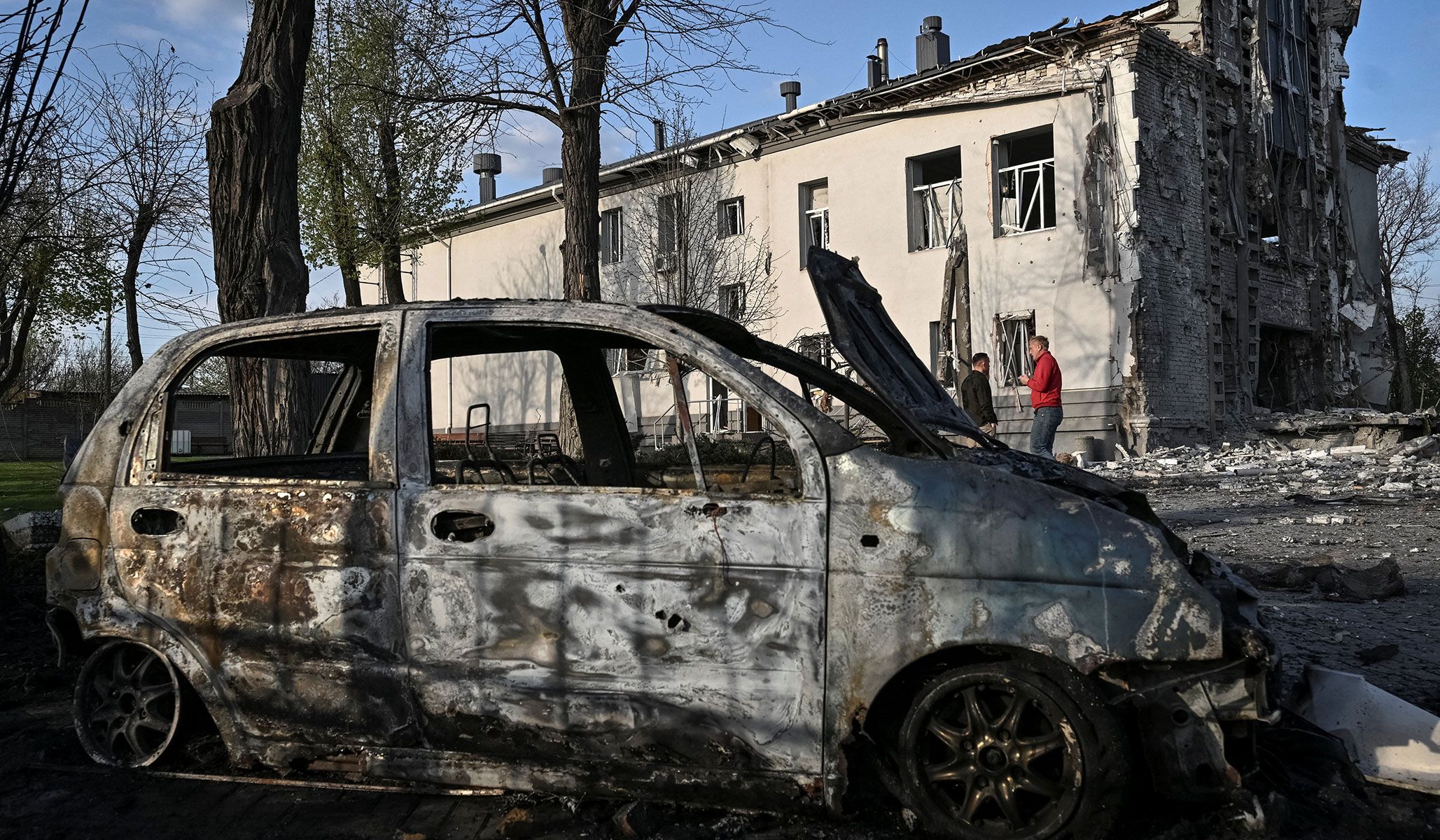 Residents stand at the site of a church hit by Russian air strike in Zaporizhzhia, Ukraine, April 16, 2026.