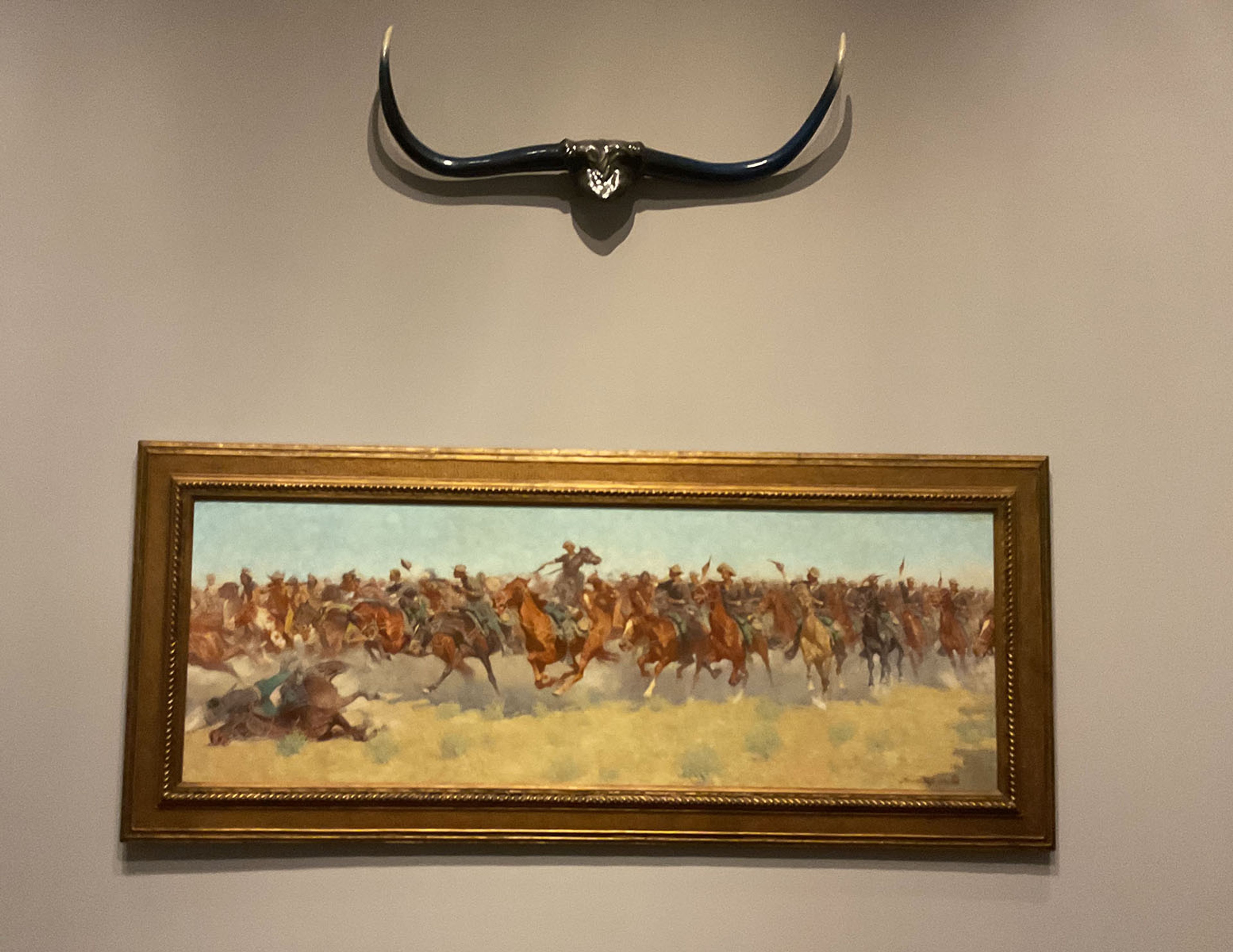 Installation view of Frederic Remington’s The Charge , 1906, oil on canvas, and Luis Jiménez’s Longhorns , together celebrating the winning of the West.