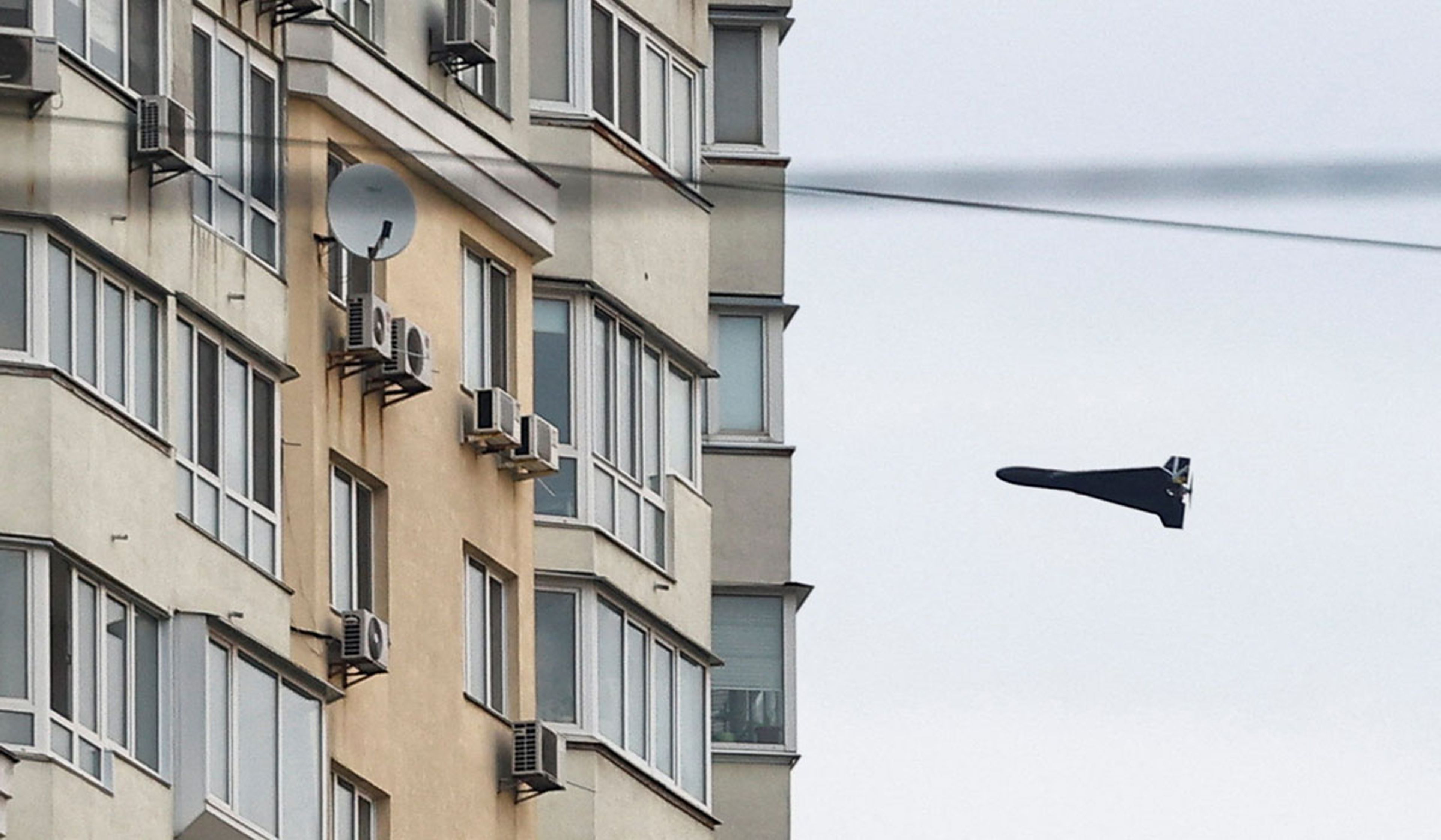 A Russian Geran 2 kamikaze drone flies next to a building in Kyiv, Ukraine, April 16, 2026.