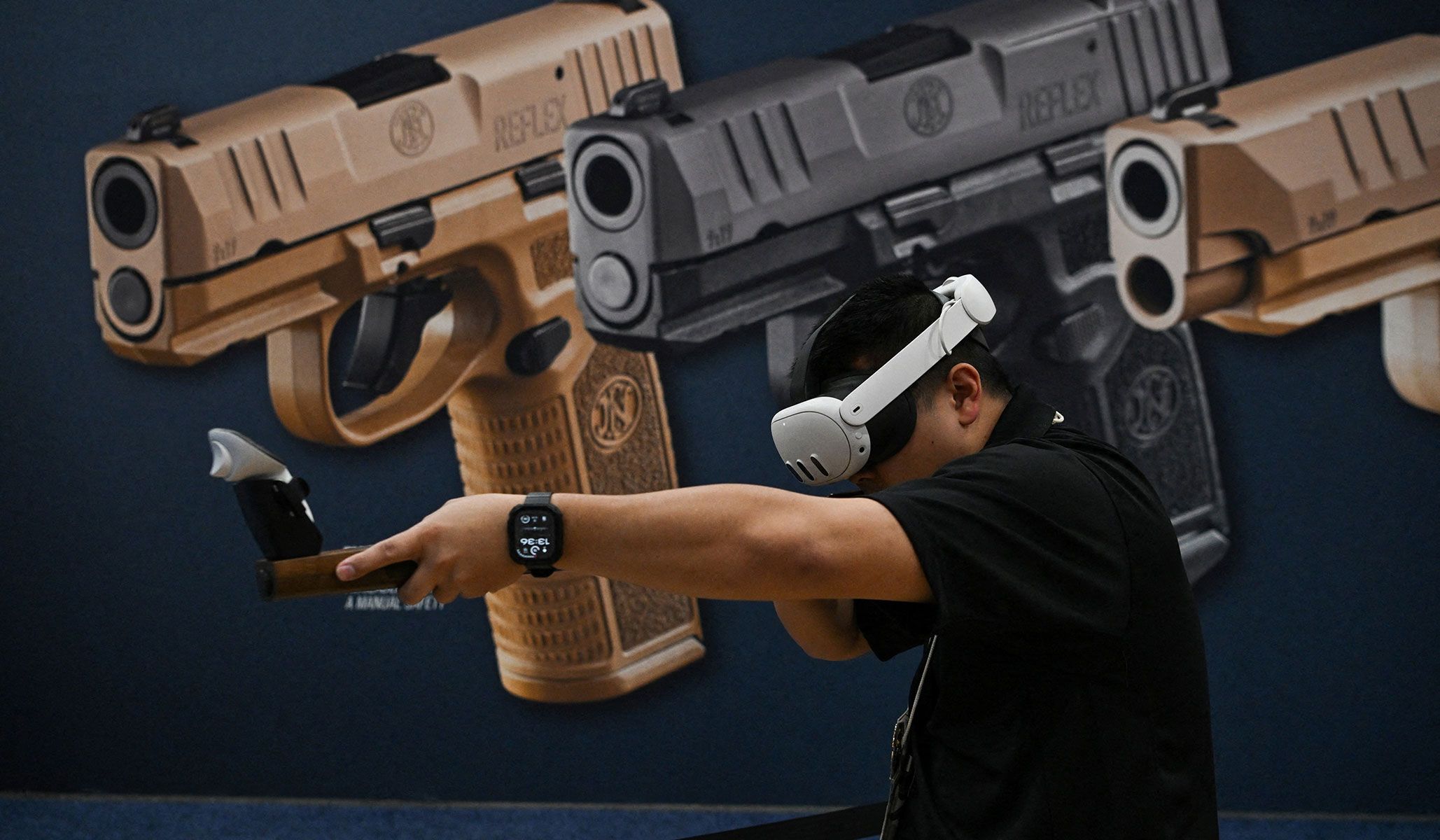 A person engages with a virtual shooting game at the National Rifle Association's annual meetings and exhibits in Houston, Texas, April 19, 2026.