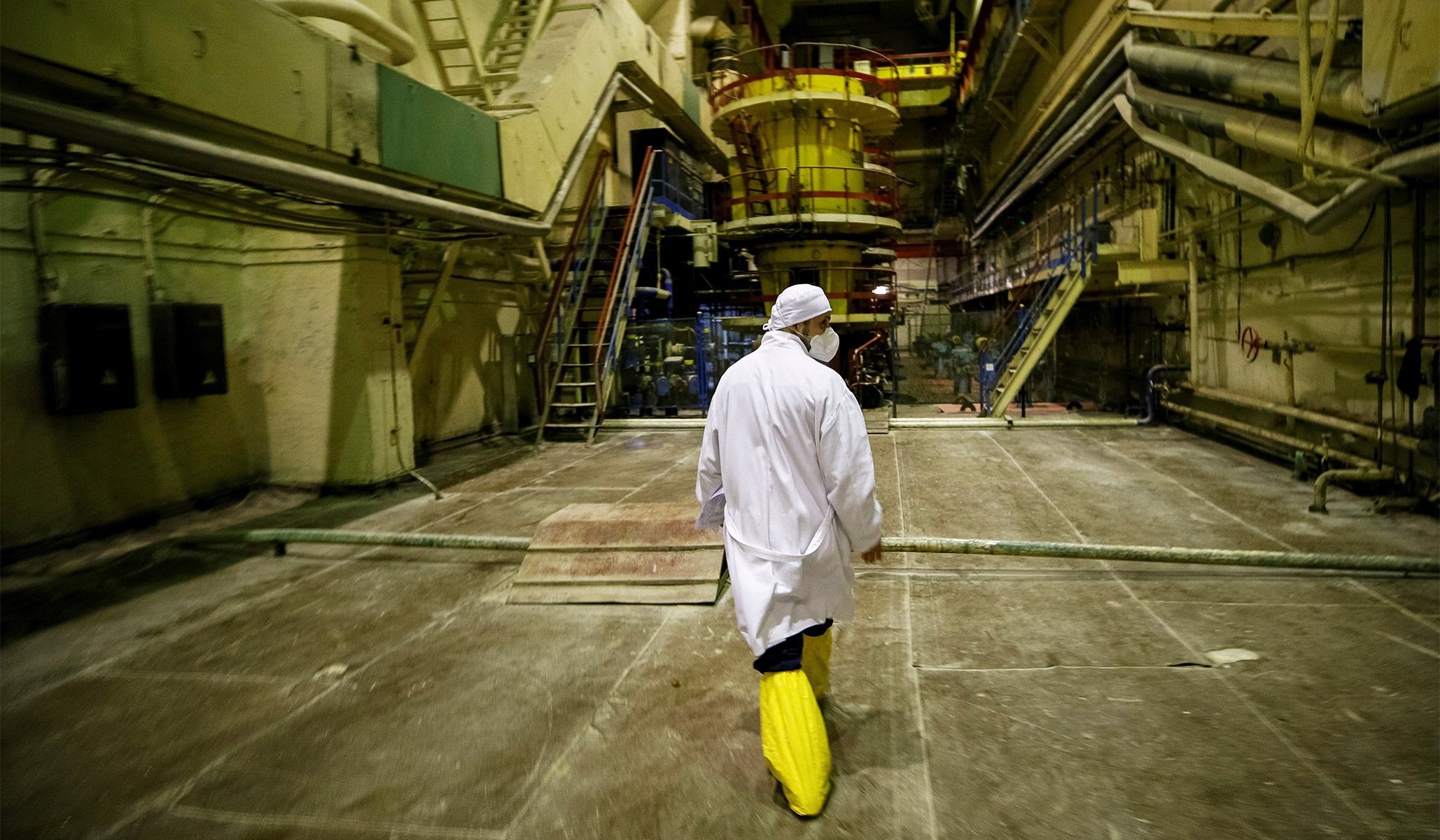 An employee walks through a pump room of the stopped third reactor at the Chernobyl nuclear power plant in Chernobyl, Ukraine, April 20, 2018.