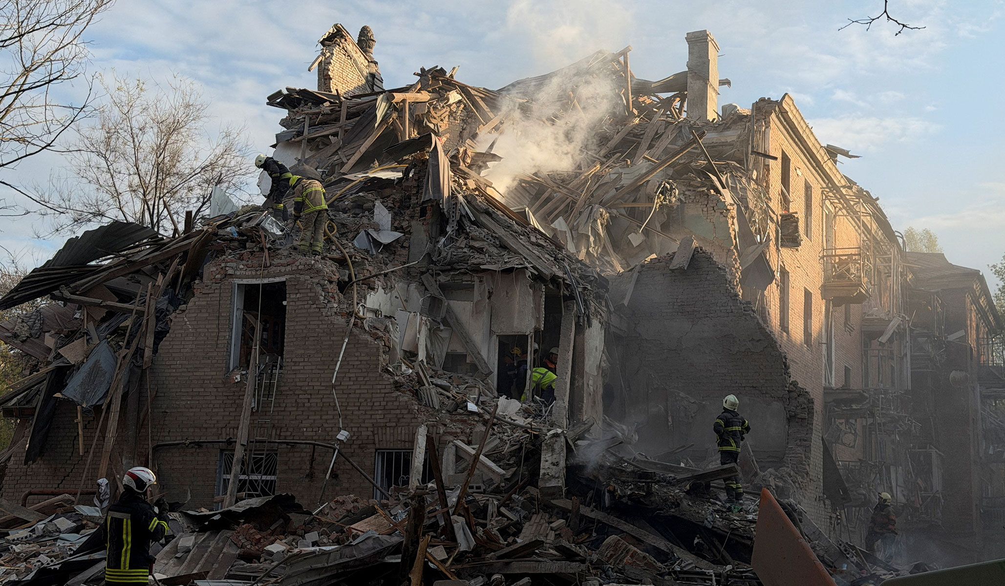 Rescuers work at the site of an apartment building hit by a Russian drone and missile strike in Dnipro, Ukraine, April 25, 2026. Picture taken using a mobile phone.