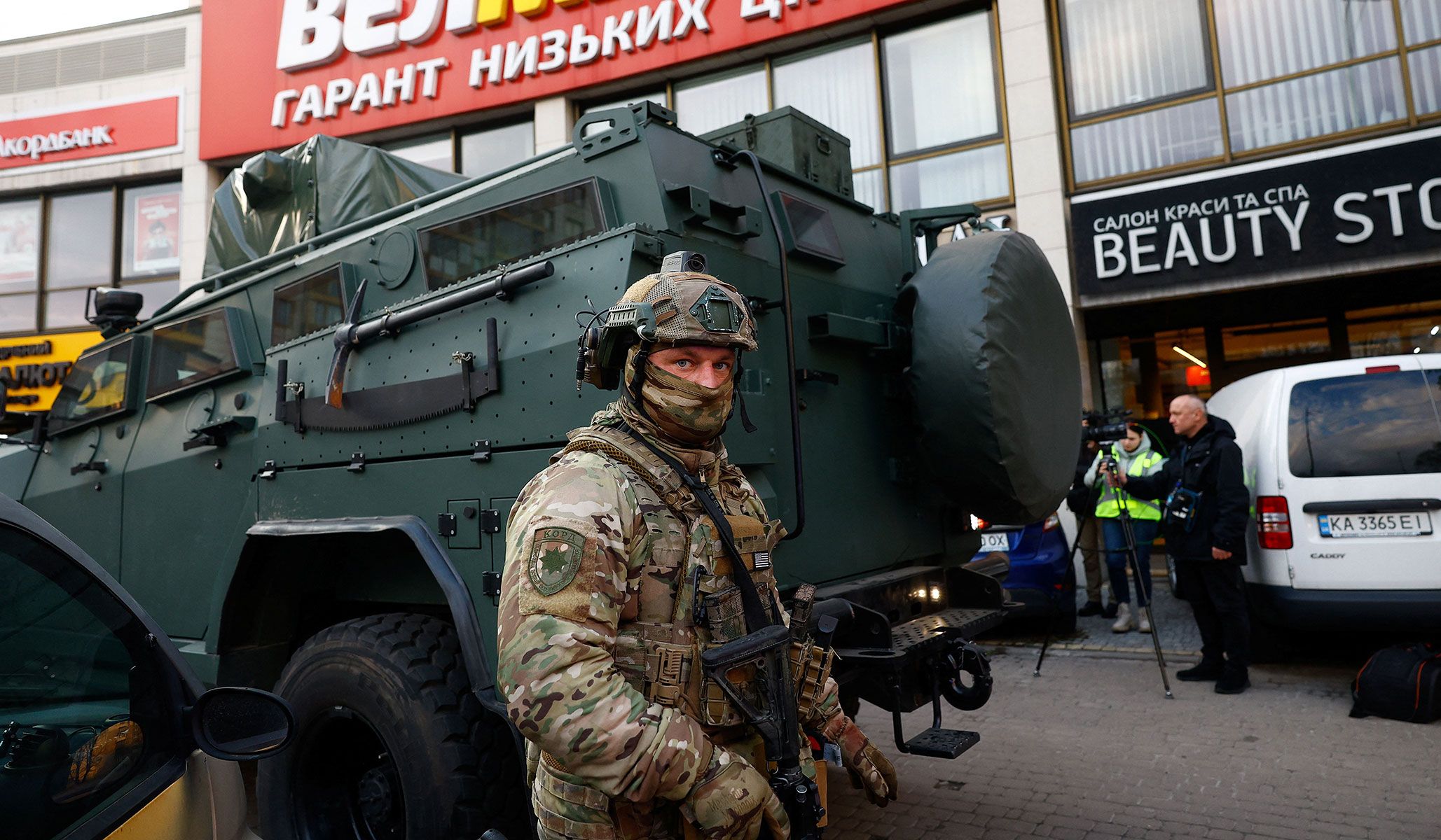 A Rapid Operational Response Unit member stands by an armored vehicle outisde a supermarket where Ukrainian police killed a man who opened fire in a city district and barricaded himself into the supermarket on Saturday in Kyiv, Ukraine, April 18, 2026.