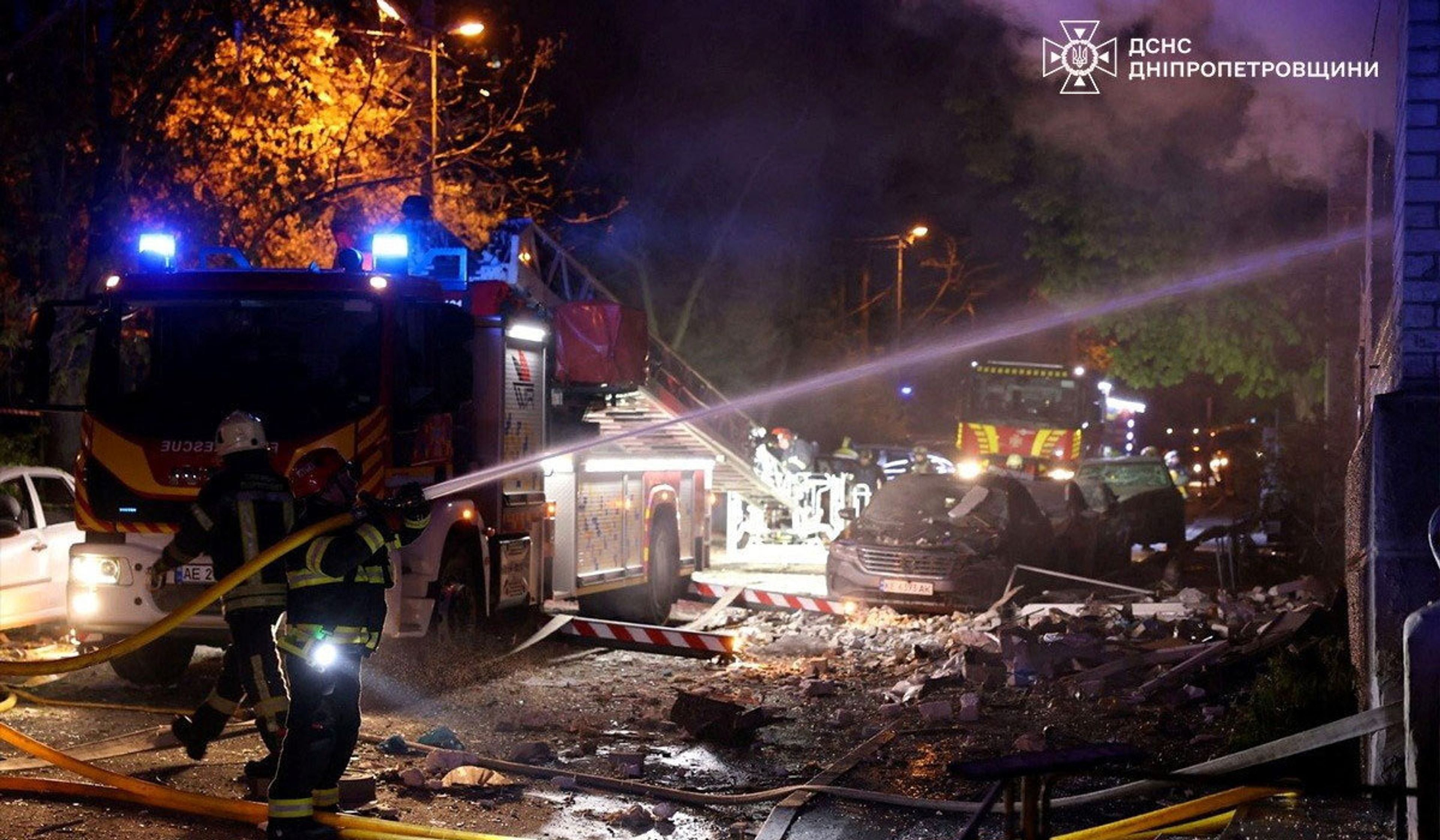Rescuers work at the site of a Russian drone strike in Dnipro, Ukraine, in a handout picture released April 23, 2026.