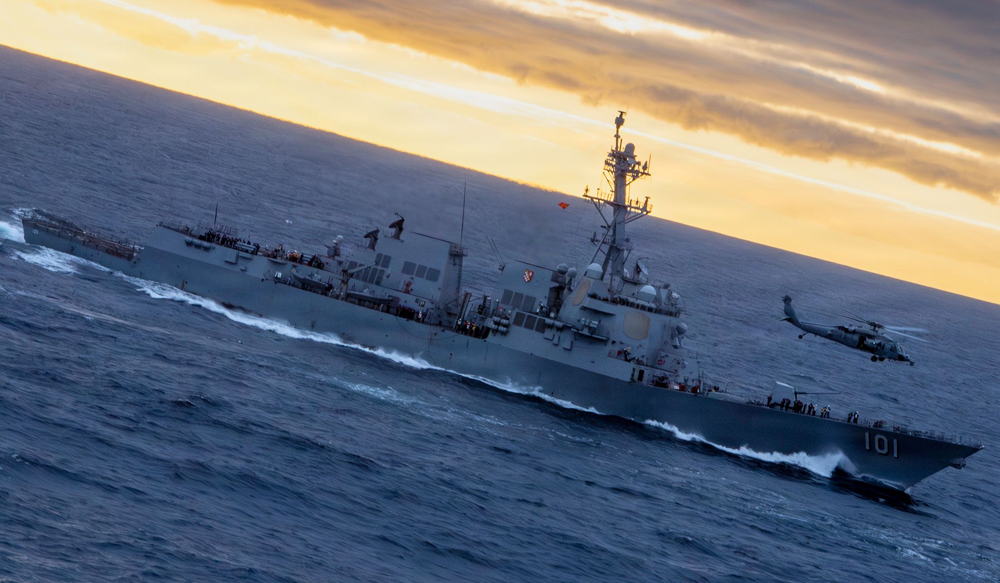 A U.S. Navy MH-60S Sea Hawk attached to the “Indians” of Helicopter Sea Combat Squadron HSC-6 flies above the Arleigh Burke-class guided missile destroyer USS <i>Gridley</i> (DDG-101) while conducting a vertical replenishment-at-sea alongside the aircraft carrier USS <i>Nimitz</i> (CVN-68) in the Pacific Ocean, April 23, 2026.