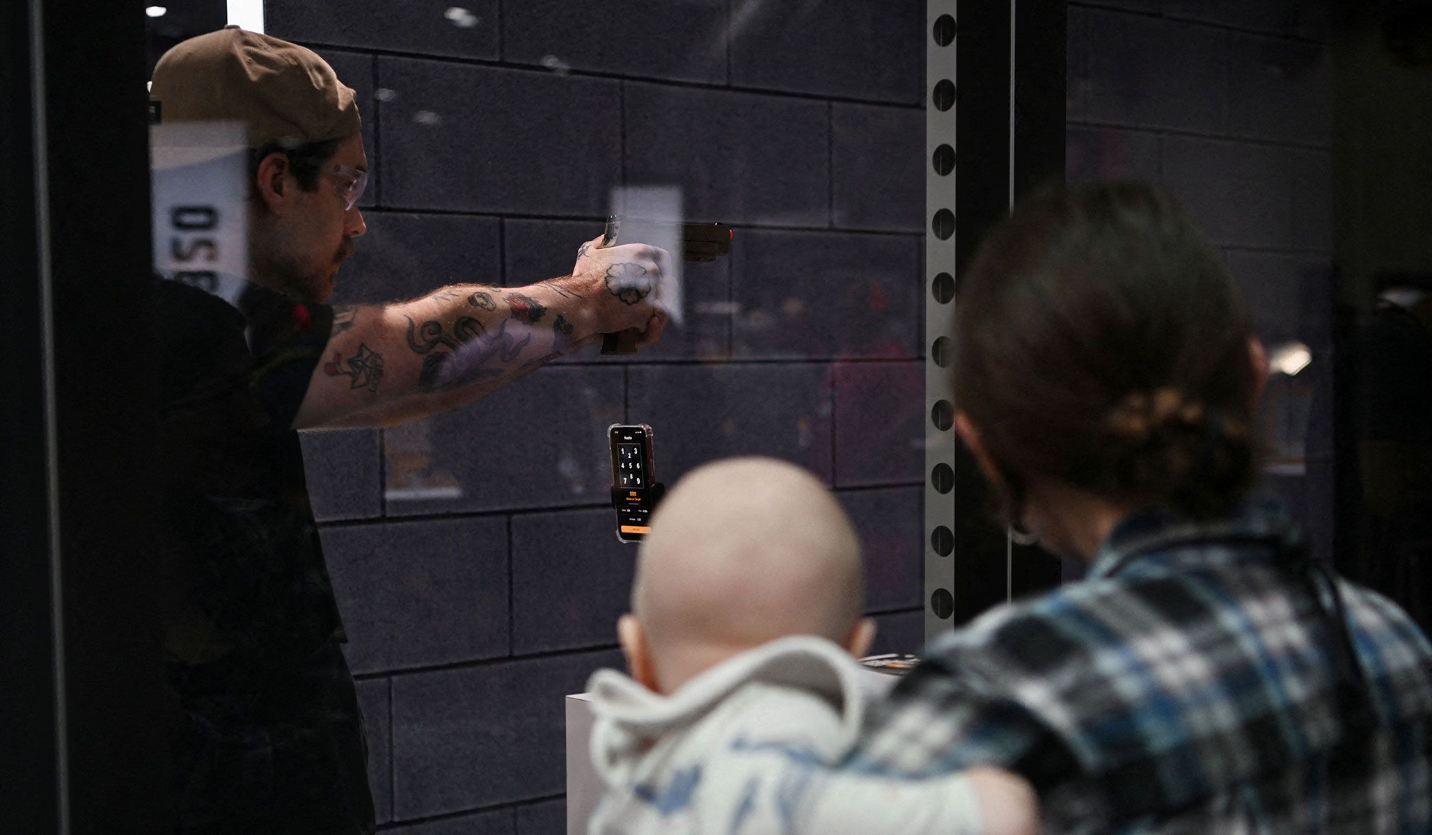 A person shoots at a target as people attend the National Rifle Association's annual meetings and exhibits in Houston, Texas, April 17, 2026.