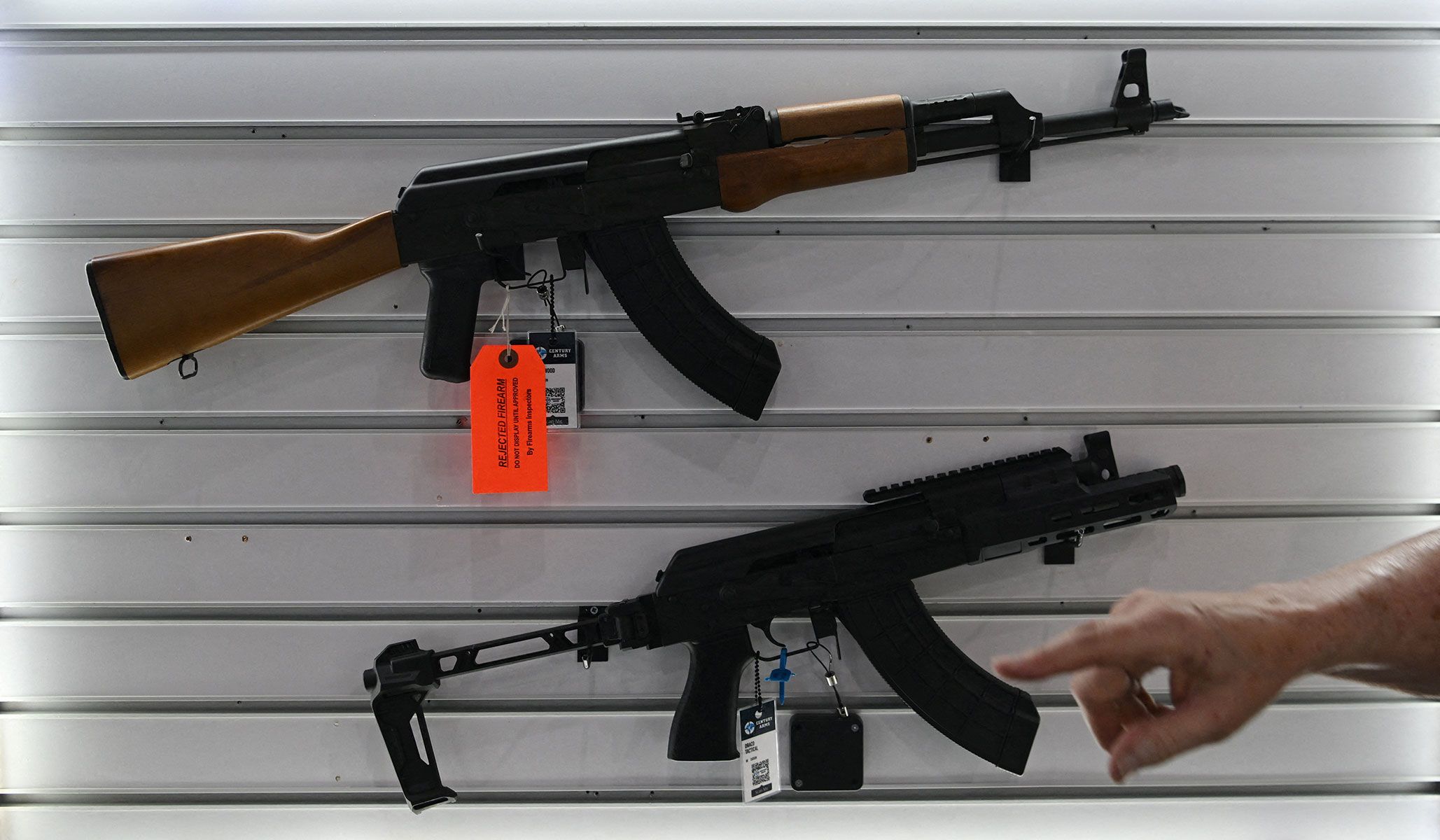 An NRA firearms examiner points out a gun that was inspected and flagged for being possibly fireable as exhibitors set up booths ahead of the National Rifle Association's annual meetings and exhibits in Houston, Texas, April 16, 2026.