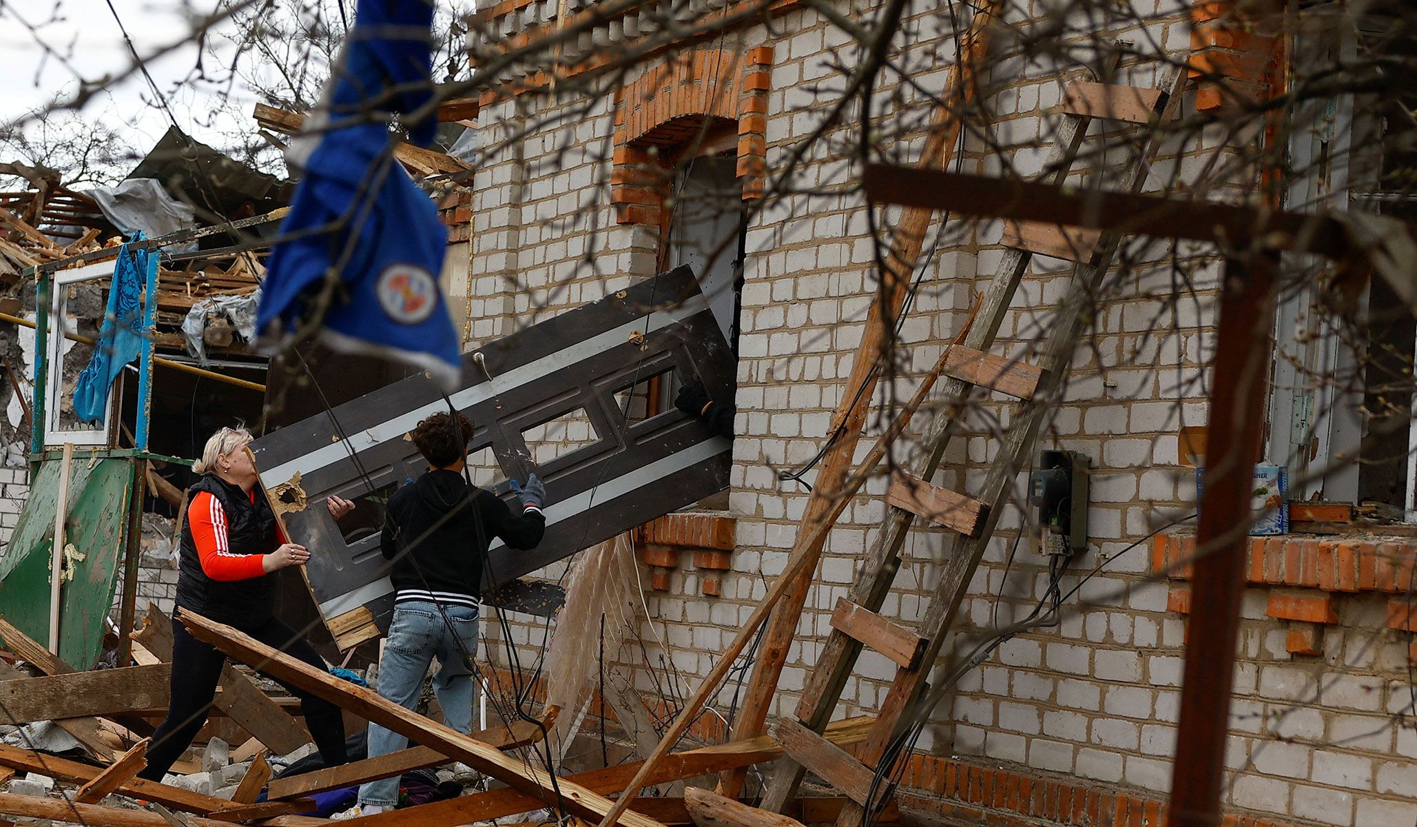 Residents remove debris at the site of a house heavily damaged during a Russian missile strike in Korosten, Zhytomy Region, Ukraine, April 3, 2026.