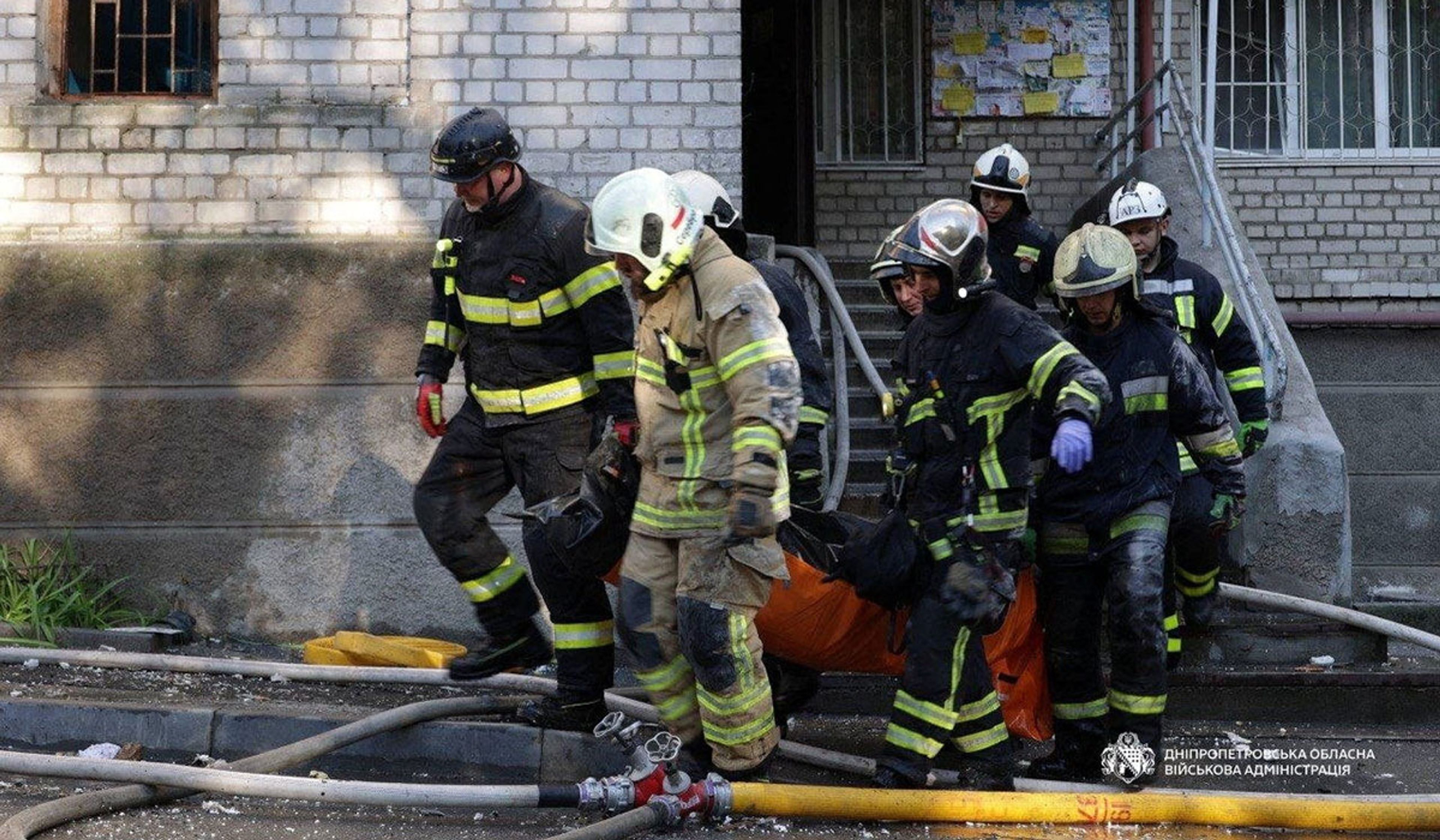 Rescuers carry a body of the person found under debris of a building which was hit during Russian drone strike in Dnipro, Ukraine, April 23, 2026.
