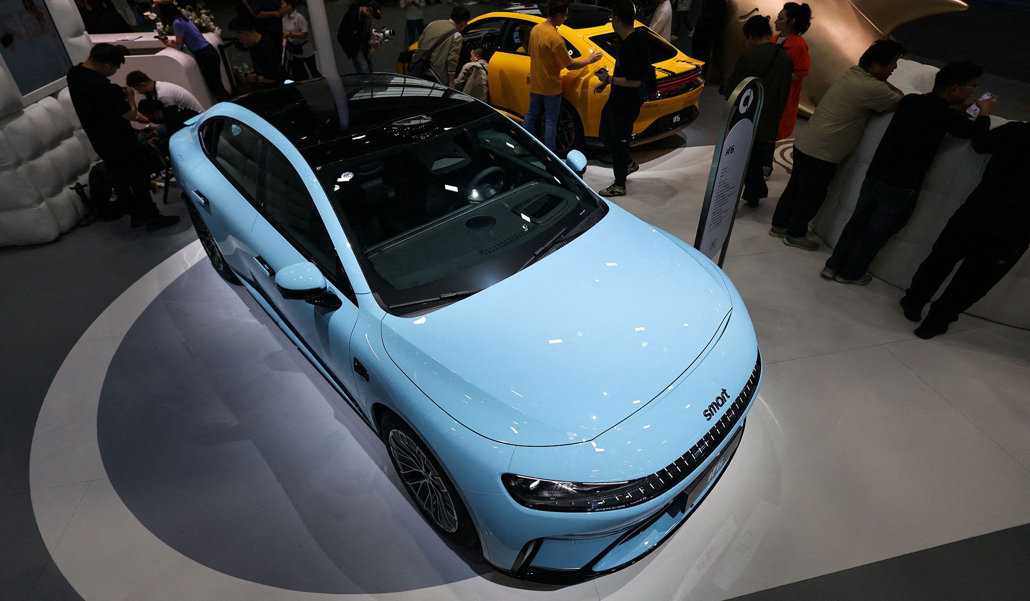 People gather around newly presented Smart #6 EHD sedans at the Beijing International Automotive Exhibition in Beijing, China, April 24, 2026.