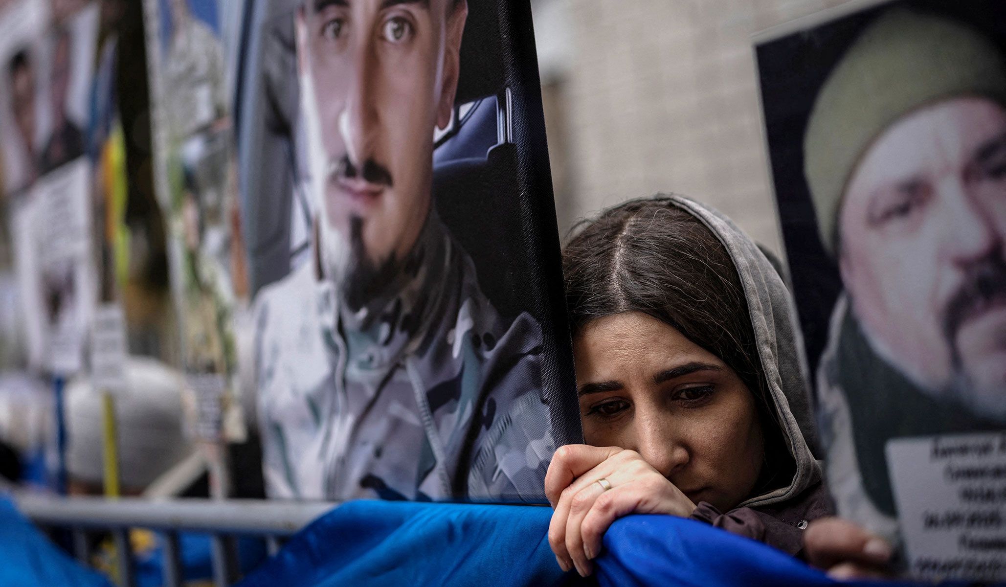 A woman waits for news about a missing loved one as some Ukrainian soldiers return from captivity after a prisoner of war swap in an undisclosed location in Ukraine, April 11, 2026.