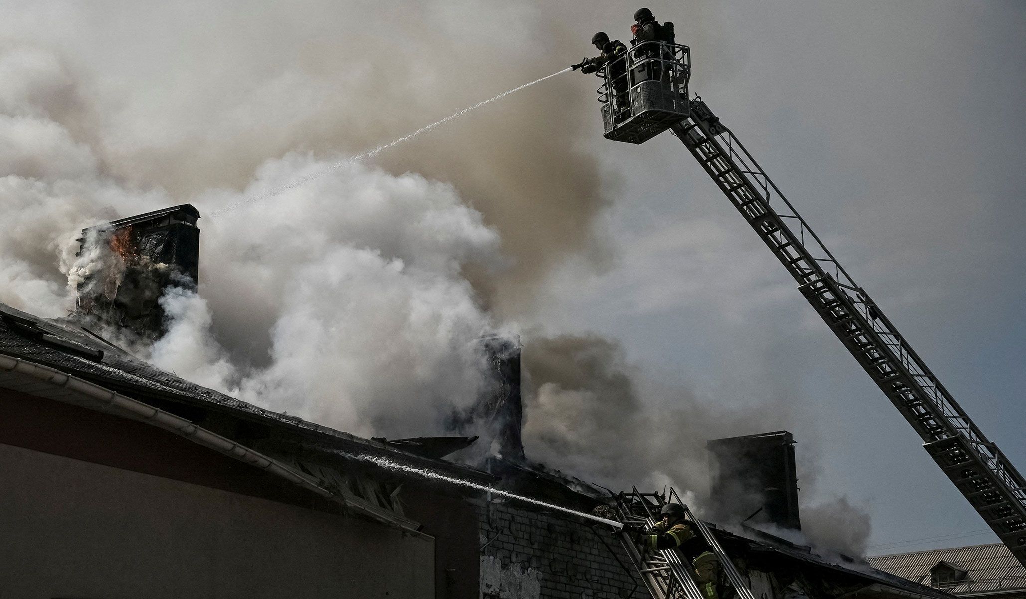 Firefighters work at the site of a building hit by a Russian drone strike in Zaporizhzhia, Ukraine, April 13, 2026.