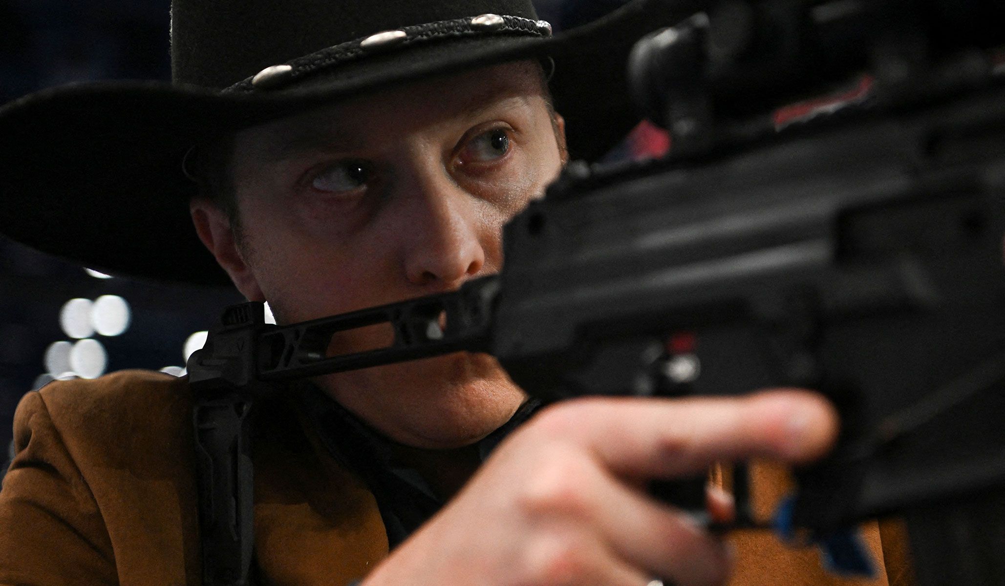 A person points a gun during the National Rifle Association's annual meetings and exhibits in Houston, Texas, April 18, 2026.