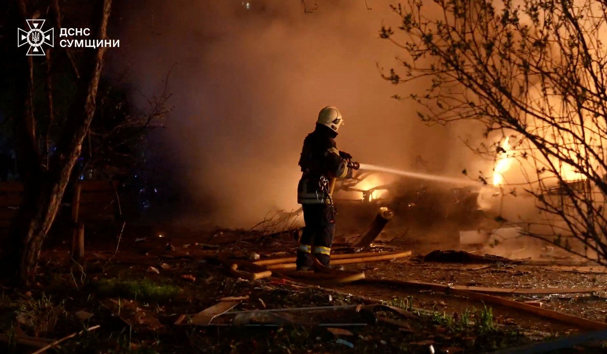 A firefighter works at a site of Russian strikes in Sumy, Ukraine, in a screen grab taken from a handout video released April 21, 2026.