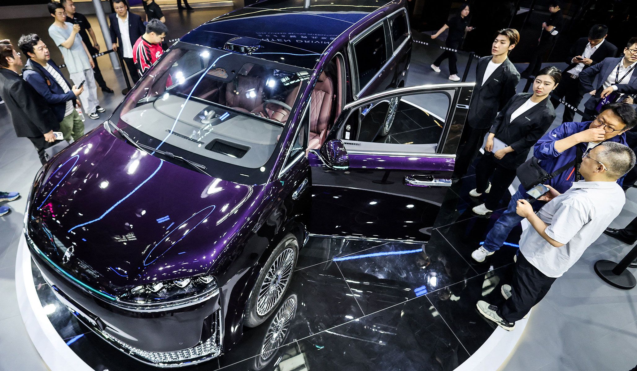 People gather next to the newly presented Chery’s brand Luxeed V9 minivan at the Beijing International Automotive Exhibition in Beijing, China, April 24, 2026.