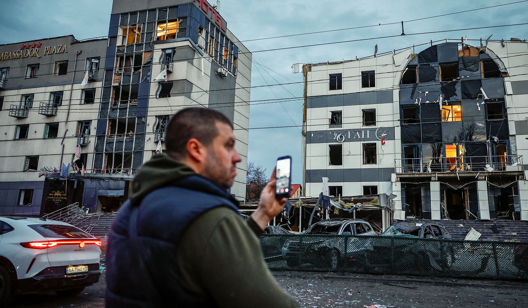 A man records using his mobile phone near the site of a Russian missile strike in Kyiv, Ukraine, April 16, 2026.