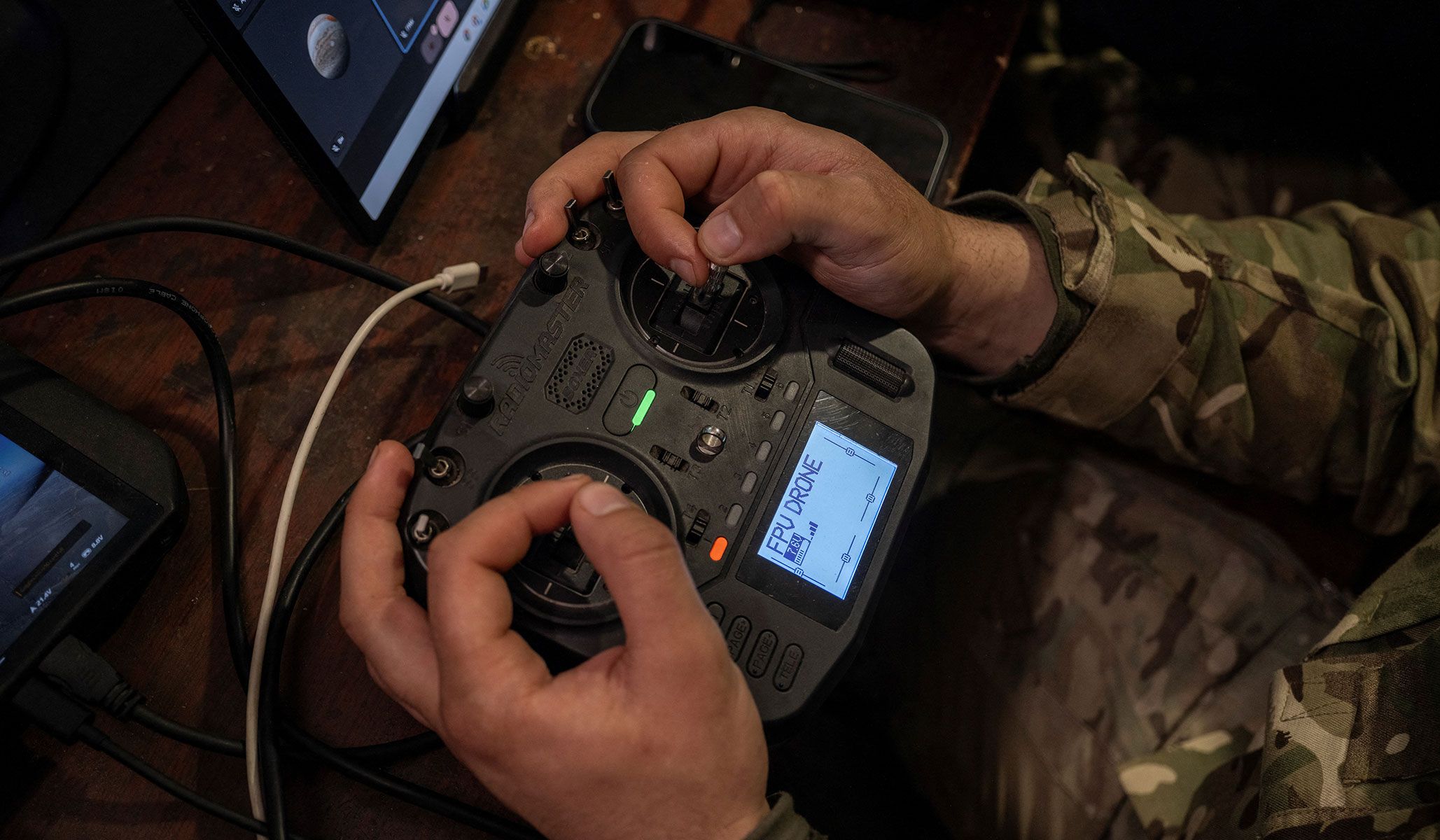 A service member of the 93rd Kholodnyi Yar Separate Mechanized Brigade of the Ukrainian Armed Forces controls an FPV-drone at a position on outskirts of the frontline town of Druzhkivka, Donetsk Region, Ukraine, April 7, 2026.