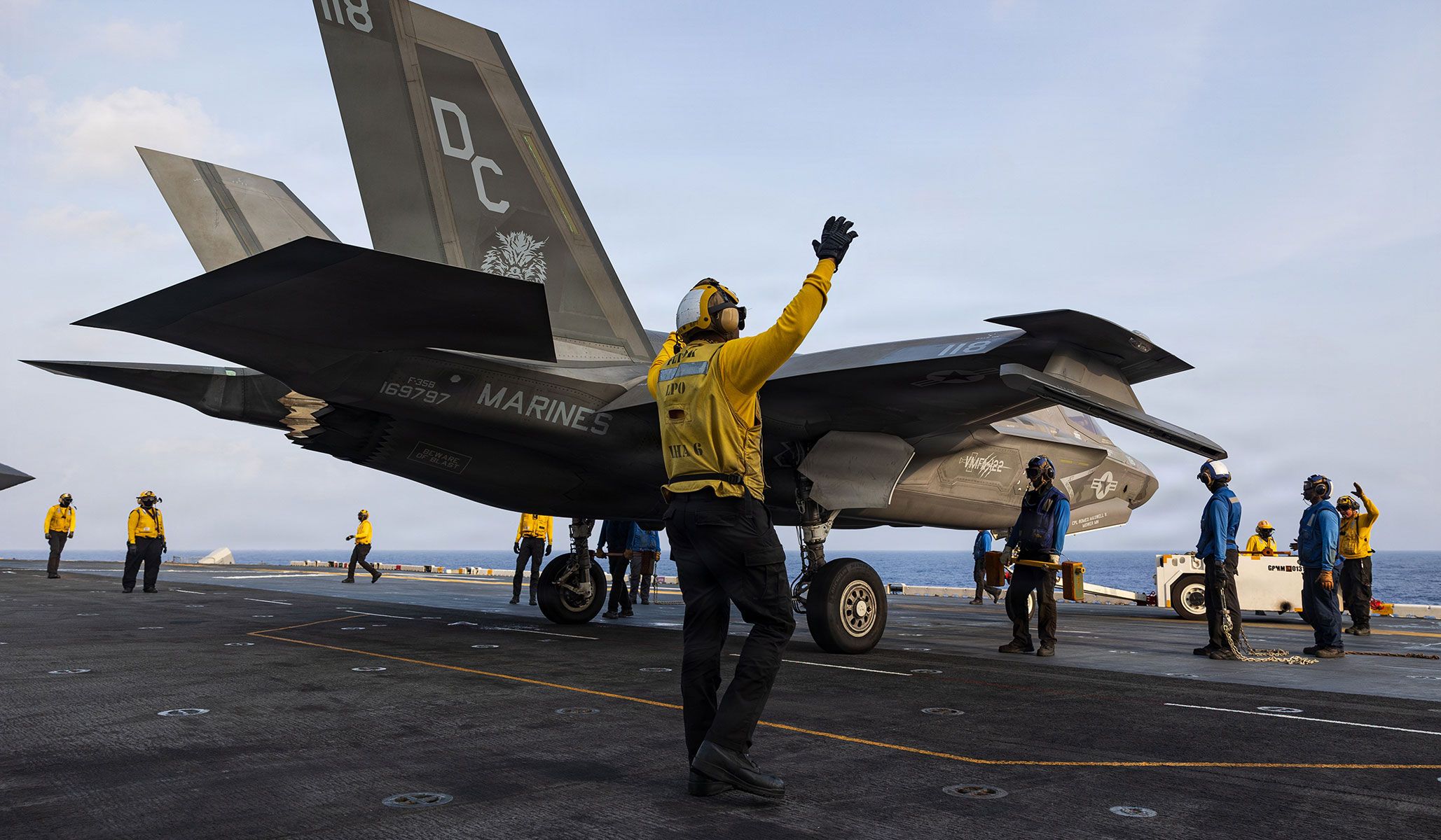 U.S. Navy sailors assigned to the Wasp-class amphibious assault ship USS <i>Boxer</i> (LHD-4) direct a Marine Corps F-35B Lightning II assigned to the “Werewolves” of Marine Fighter Attack Squadron VMFA-122, 11th Marine Expeditionary Unit, during flight operations in the Pacific Ocean, April 18, 2026.