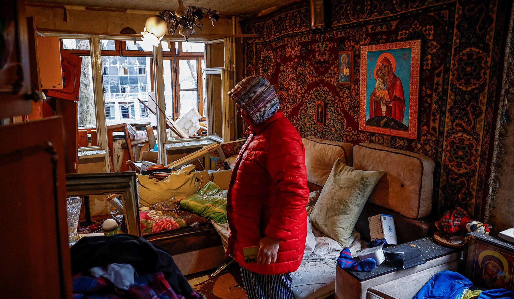 Yana stands in her apartment, damaged during a Russian missile strike in Kyiv, Ukraine, April 16, 2026.