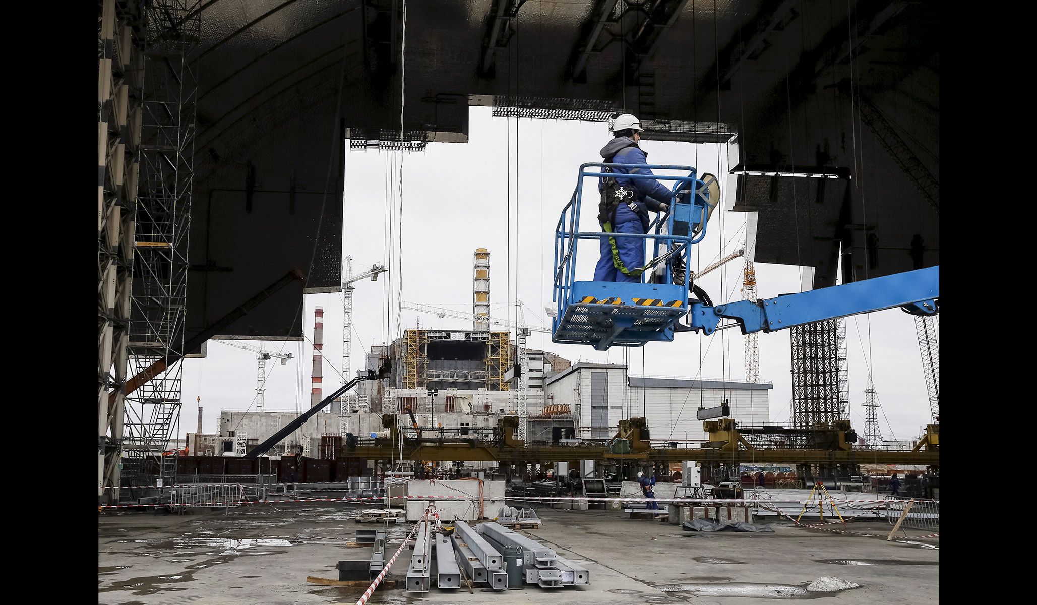 An employee works on the New Safe Confinement structure at the site of the Chernobyl nuclear power plant in Ukraine, March 23, 2016.